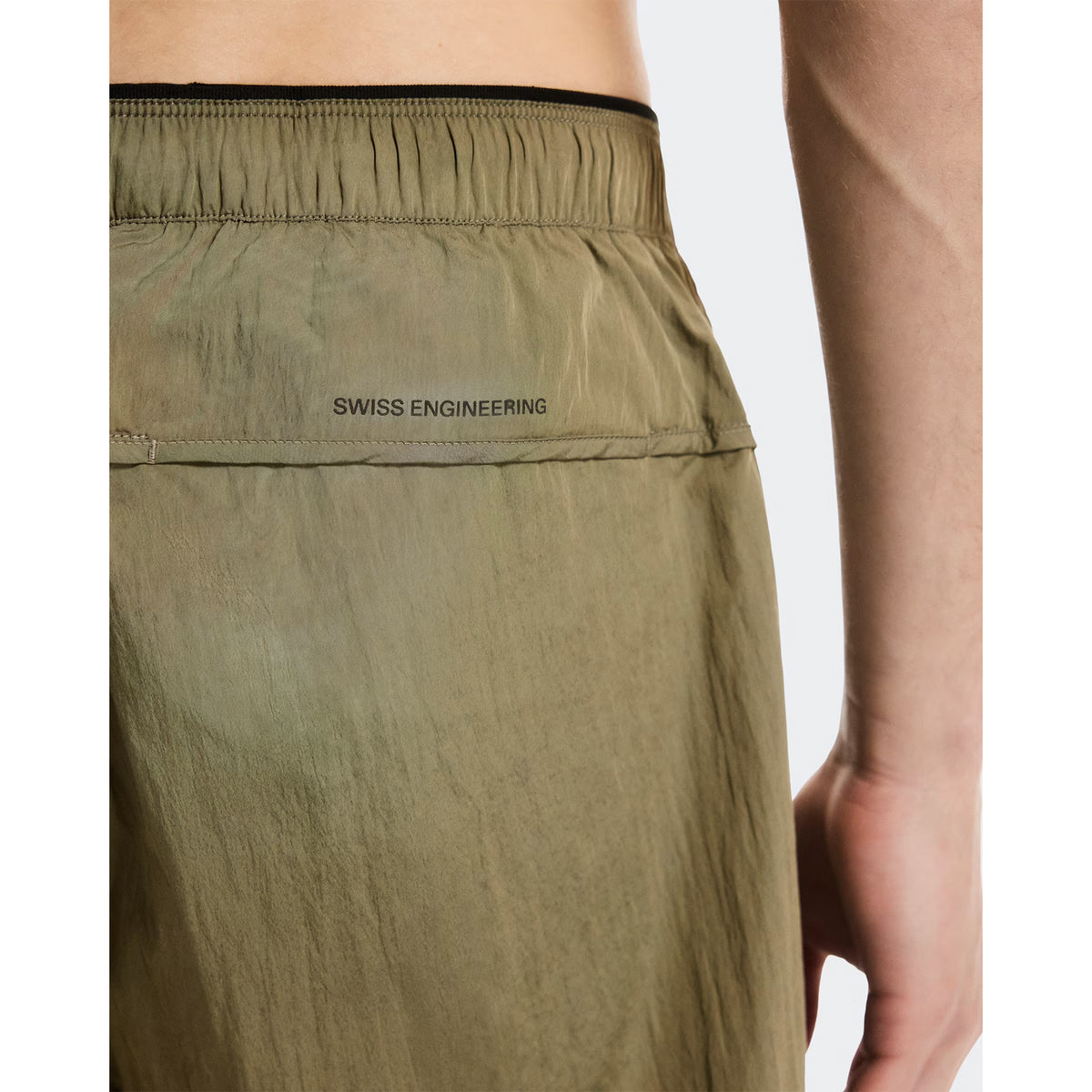 Men's On Performance Volt Shorts Safari close-up of Swiss engineering detail showing On DryTec technology with windproof water-repellent construction and multiple storage solutions