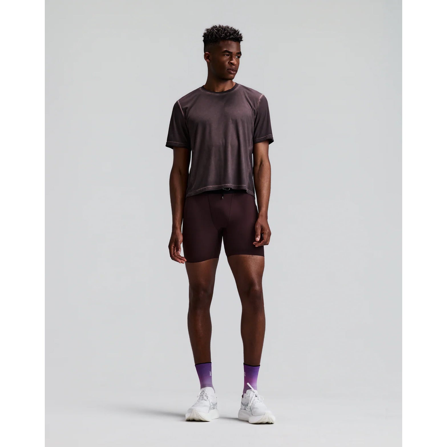 Men's Bandit SoLite Quarter Tights Espresso front full body view on male runner showing featherweight SoLite compression with waterproof drop-in leg pockets and GripDot hem grip for road running and racing