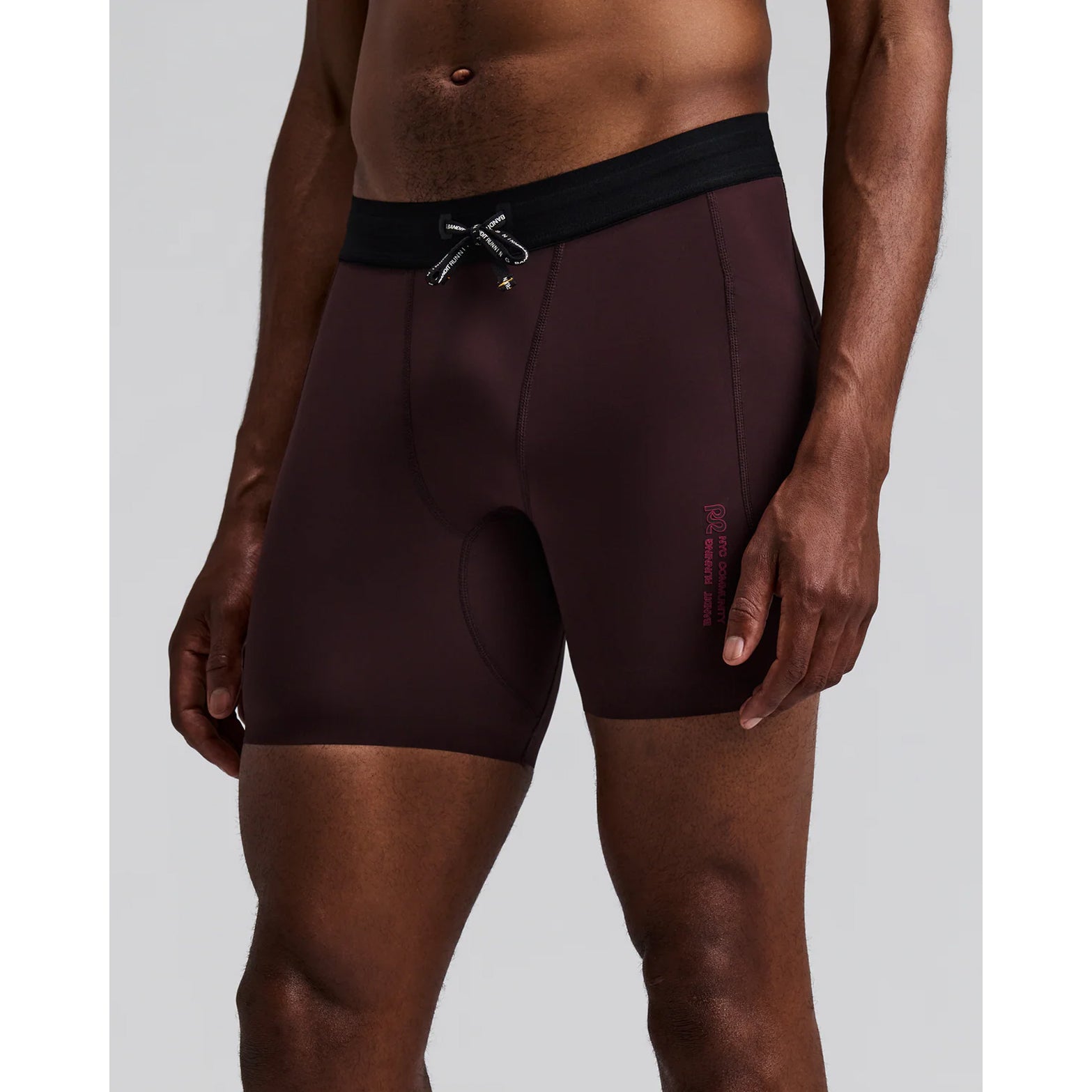 Men's Bandit SoLite Quarter Tights Espresso front view on male runner showing SoLite featherweight compression with double-layered front fabric and waterproof drop-in leg pockets
