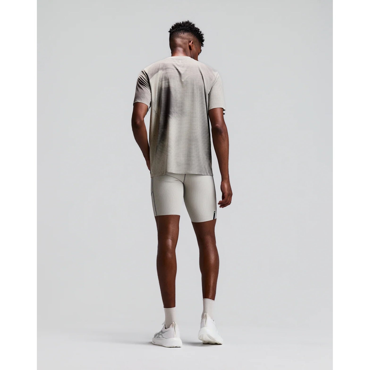 Men's Bandit Specter Performance Tee Slate Plaster back full body view on male runner showing reflective centre back graphic with lightweight Specter sweat-wicking construction for comfortable running