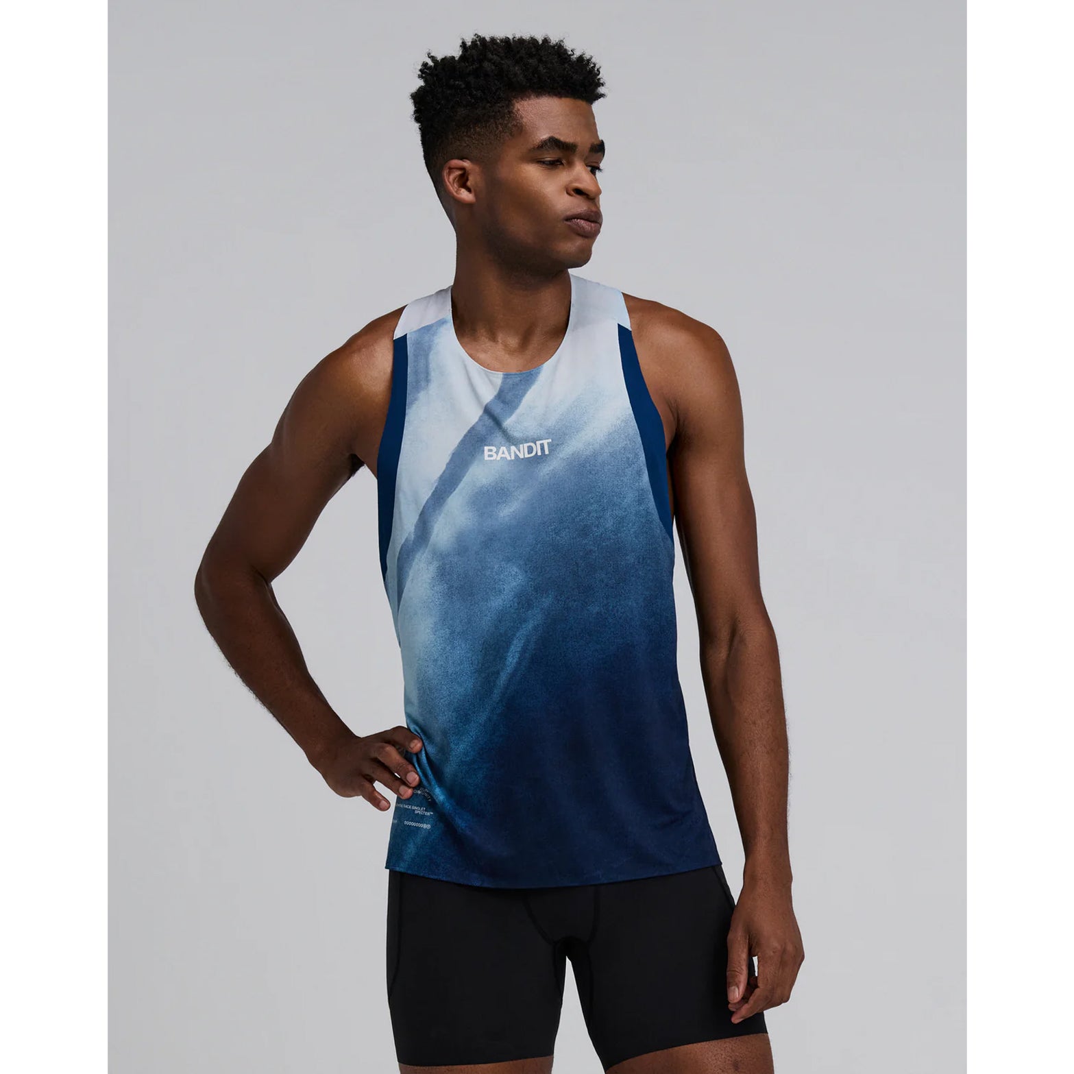Bandit Specter Race Singlet men's in Undertow Ink Blue Multi — front view worn on model showing lightweight race fit, narrow straps, undertow ink blue multi Specter™ fabric and reflective graphic hits