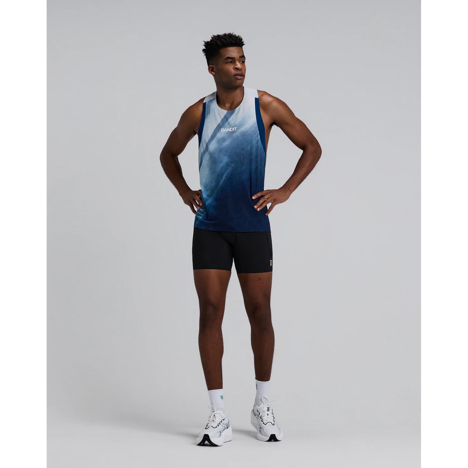 Bandit Specter Race Singlet men's in Undertow Ink Blue Multi — full body front view worn on model showing lightweight race silhouette, narrow straps, undertow ink blue multi Specter™ fabric and reflective graphic hits in motion