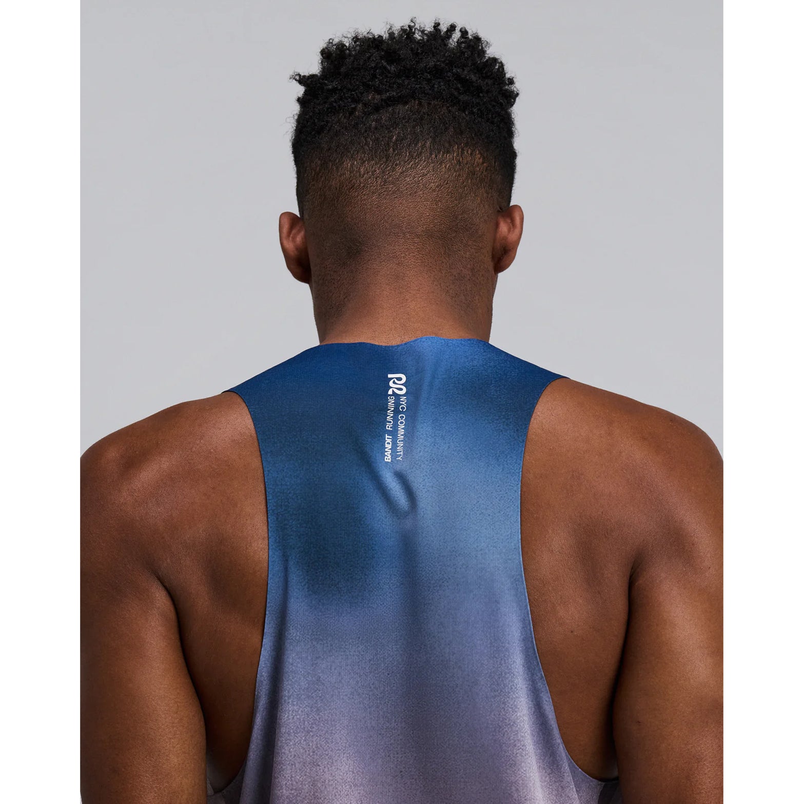 Bandit Specter Shorty Race Singlet men's in Flow State Aegean Multi — closeup of back showing deep racerback construction, Acrofuse™ bonded seam detail and flow state aegean multi Specter™ performance fabric