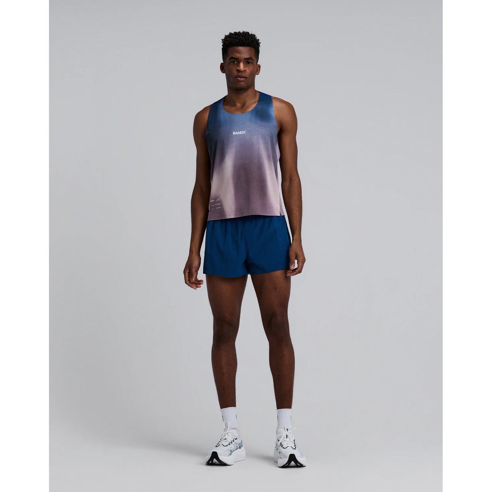 Bandit Specter Shorty Race Singlet men's in Flow State Aegean Multi — full body front view worn on model showing cropped race silhouette, narrow straps, flow state aegean multi Specter™ fabric and reflective graphic hits in motion