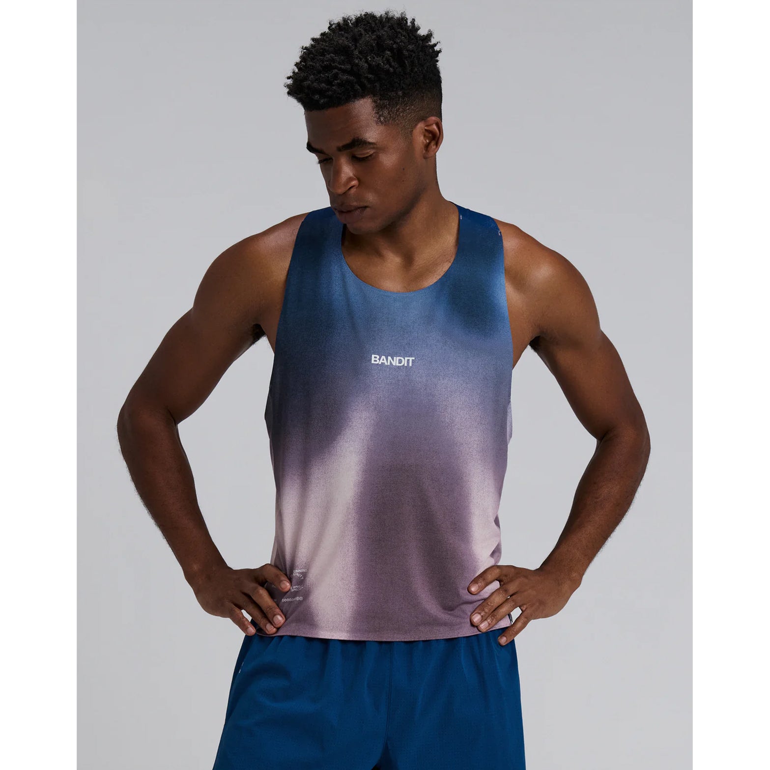 Bandit Specter Shorty Race Singlet men's in Flow State Aegean Multi — front view worn on model showing cropped race fit, narrow straps, flow state aegean multi Specter™ fabric and reflective graphic hits