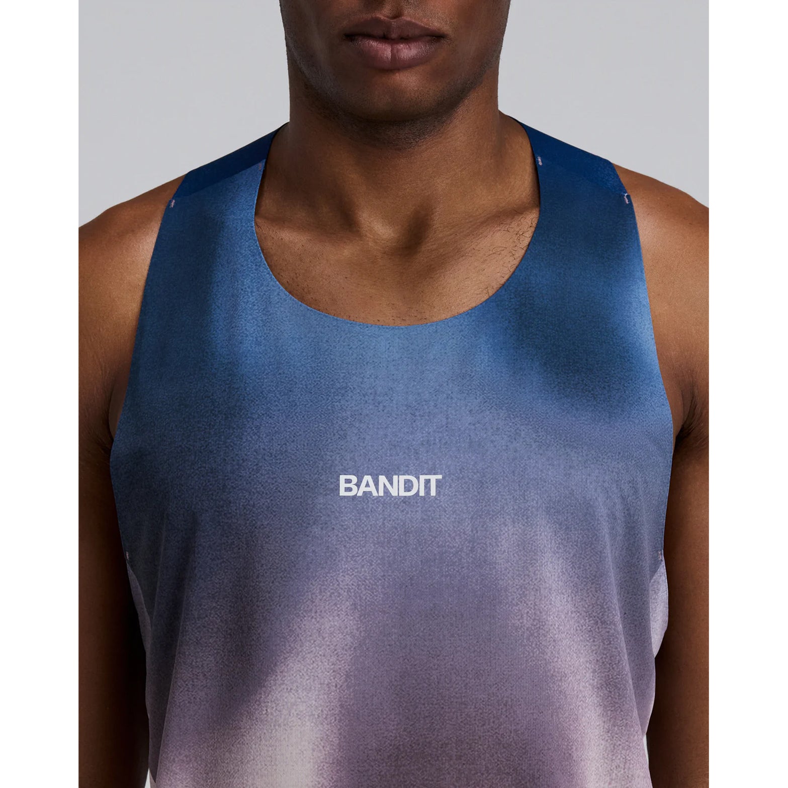 Bandit Specter Shorty Race Singlet men's in Flow State Aegean Multi — closeup of front showing narrow strap construction, cropped hem detail and flow state aegean multi Specter™ performance fabric
