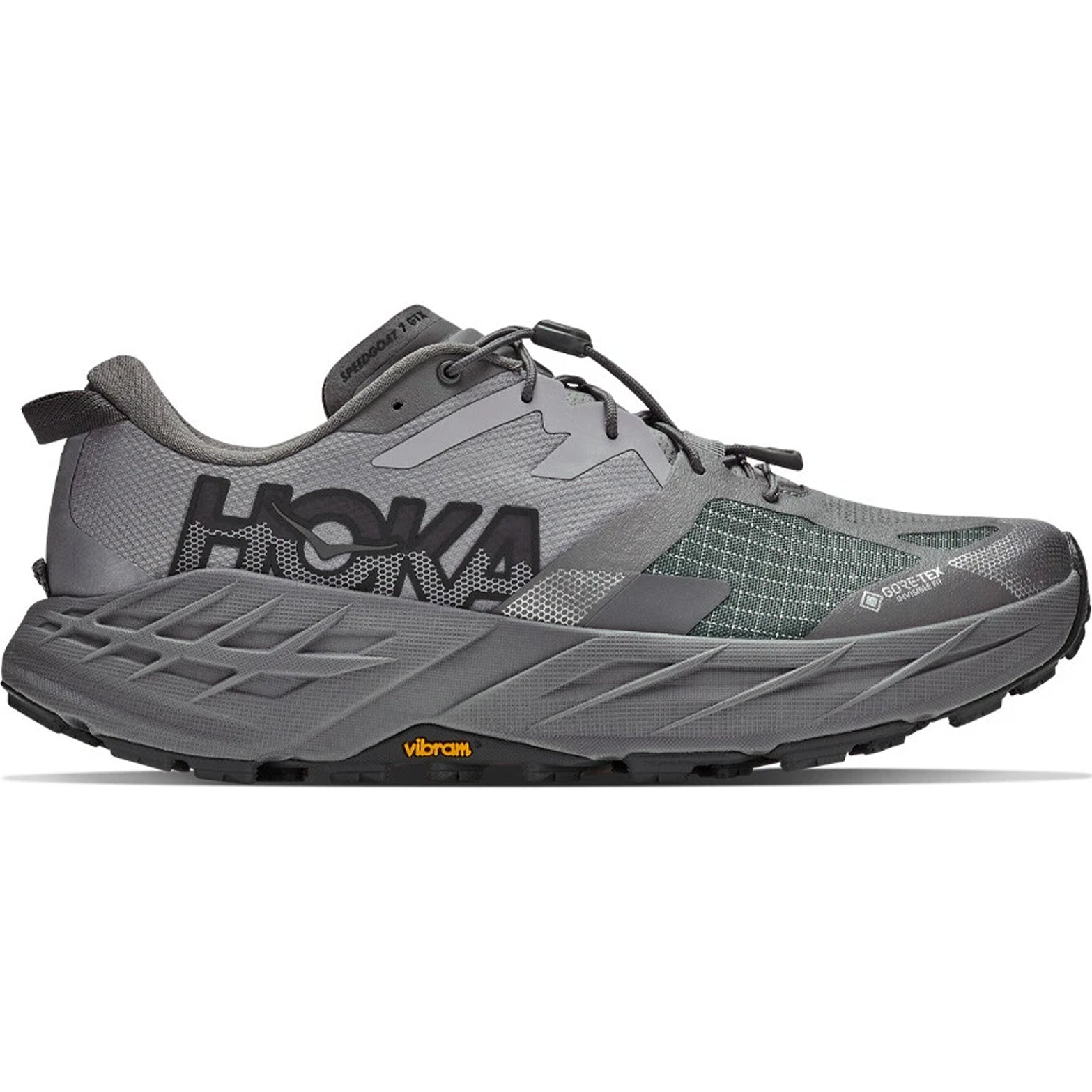 A men’s Hoka Speedgoat 7 GORE-TEX trail running shoe in Asteroid/Galactic Grey, featuring black accents, a Vibram sole, and a visible GORE-TEX label. Designed as waterproof trail running shoes, it is displayed from the side against a white background.