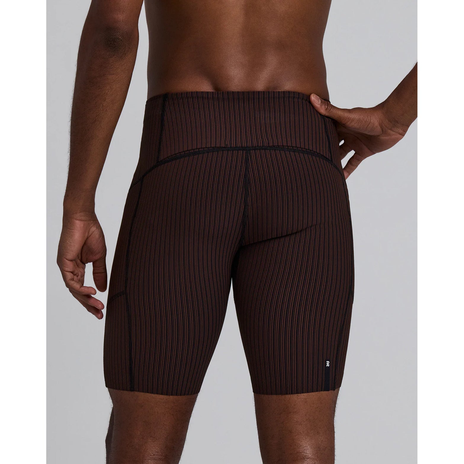 Bandit Striped Cadence 7 Pocket Half Tights men's in Cacao / Black — back view worn on model showing seven-pocket storage system, gel pocket placement and cacao and black Striped Cadence™ ribbed knit fit
