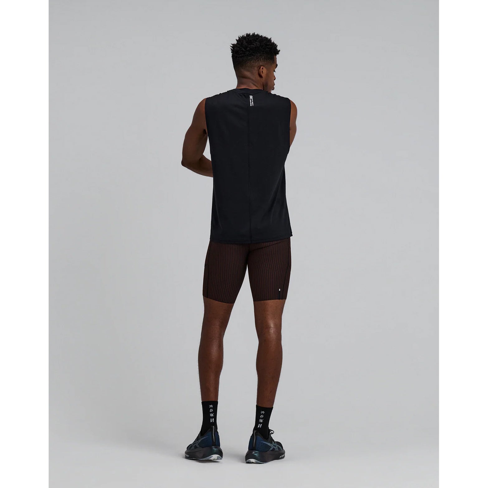 Bandit Striped Cadence 7 Pocket Half Tights men's in Cacao / Black — full body back view worn on model showing seven-pocket storage system, gel pocket placement and cacao and black Striped Cadence™ ribbed knit compression fit in motion