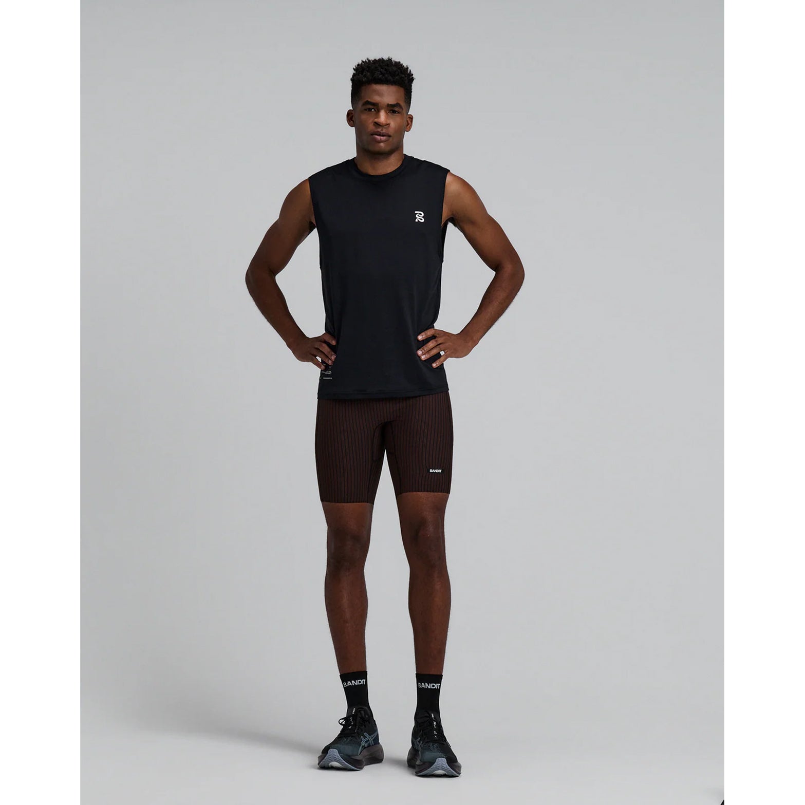 Bandit Striped Cadence 7 Pocket Half Tights men's in Cacao / Black — full body front view worn on model showing compression fit silhouette, double-layered front fabric and cacao and black Striped Cadence™ ribbed knit in motion