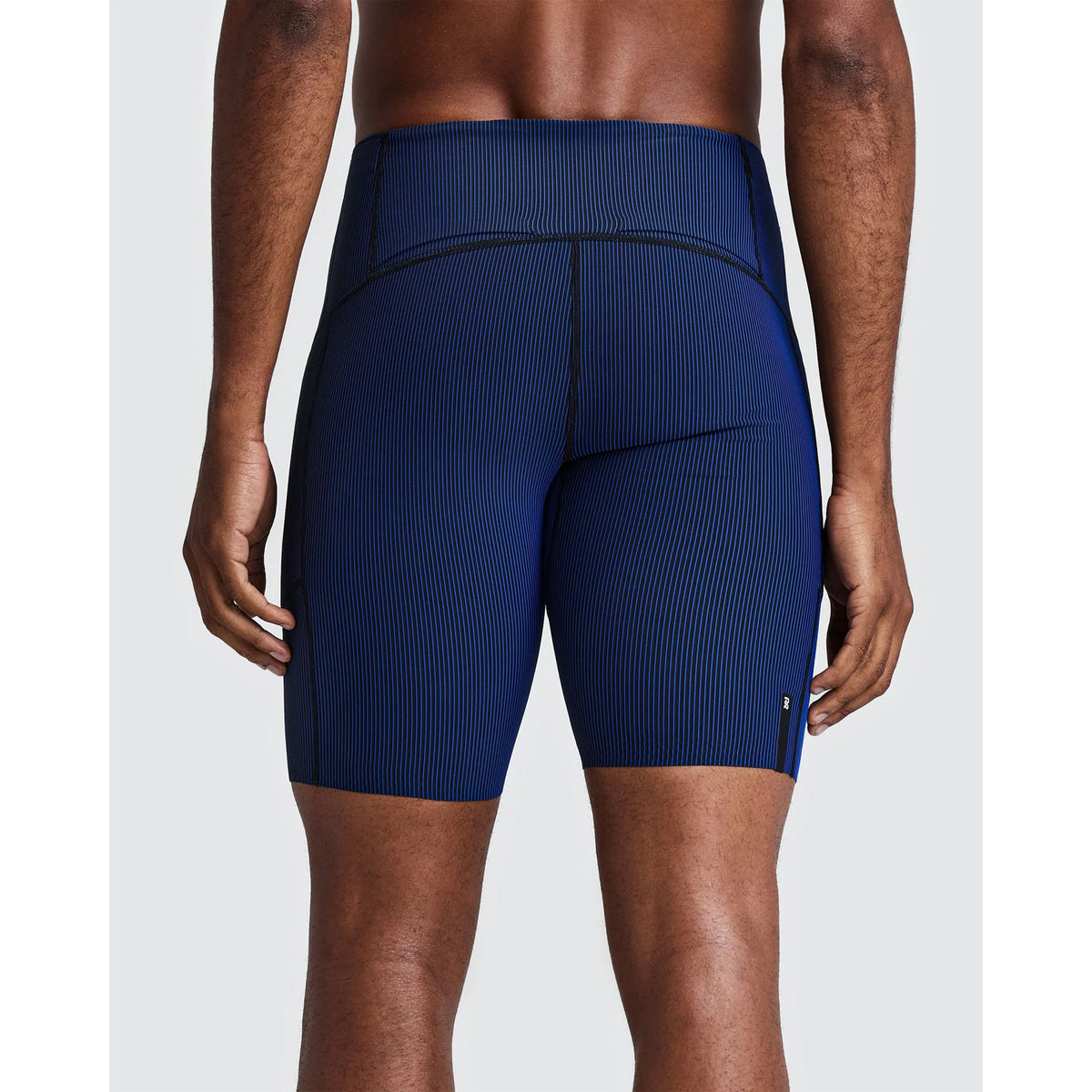 Back view of Men’s Striped Cadence Half Tights Black / Bauhaus Blue, featuring blue vertically striped athletic half tights with black stitching and a seven-pocket system.