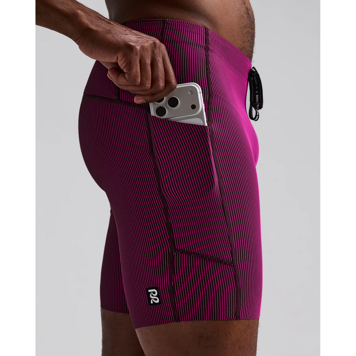 Men's Bandit Striped Cadence Quarter Tights Espresso Azalea close-up of waterproof side leg phone pocket showing secure hidden storage with zero-bulk design for race day essentials without bounce