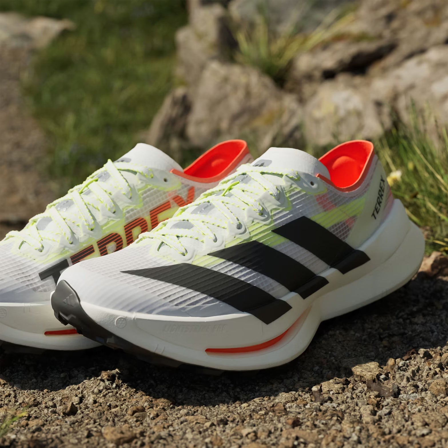 Men's Terrex Agravic Speed Ultra 2 Trail Running Shoes Cloud White Core Black Semi Impact Orange close-up pair side view showing LIGHTSTRIKE PRO midsole and seamless overlays