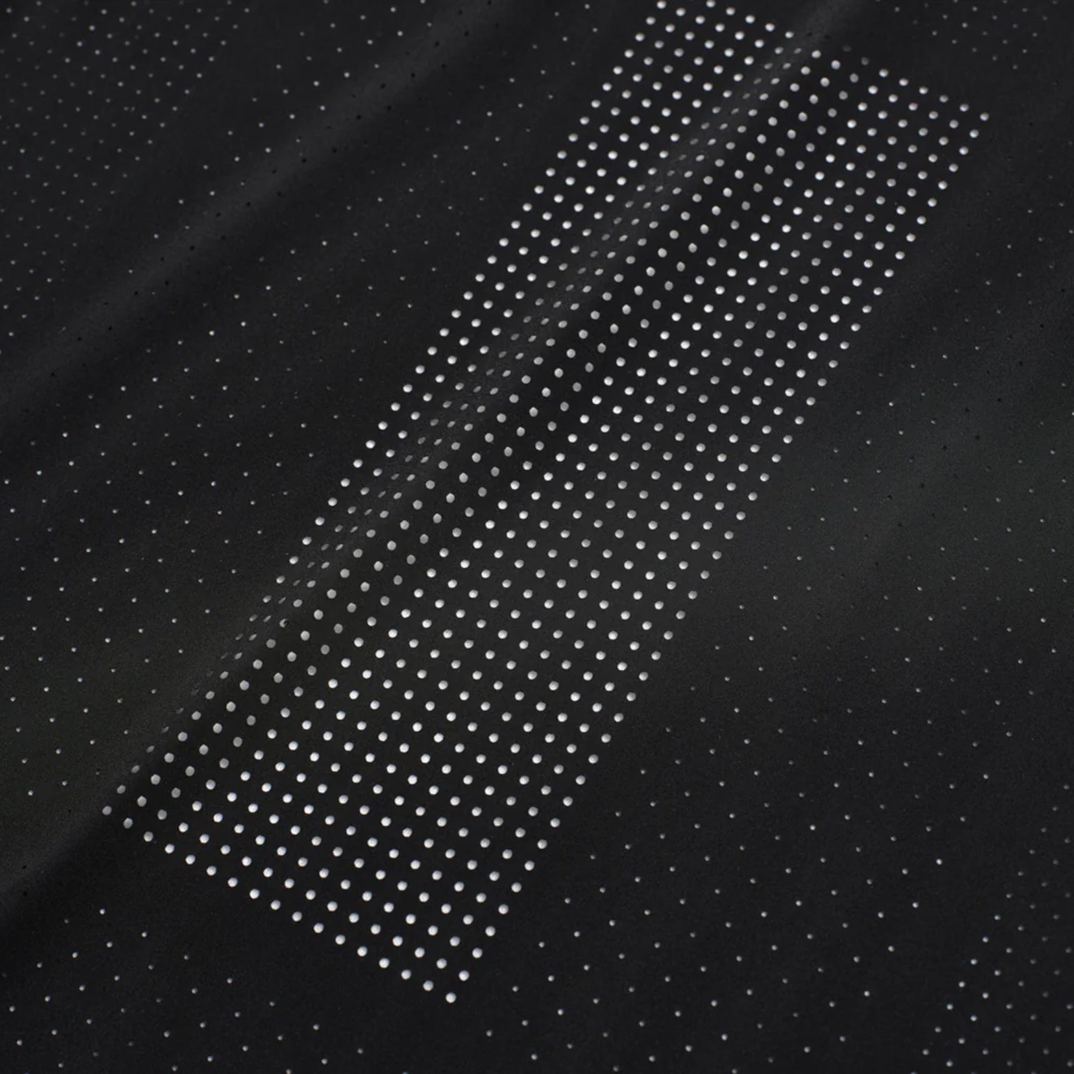 Men's Raide Thermal Dispersion Tee Black close-up of 115gsm Italian-knit microfibre showing cool-to-touch construction with four-way stretch and laser-cut perforation detail for lightweight breathable running