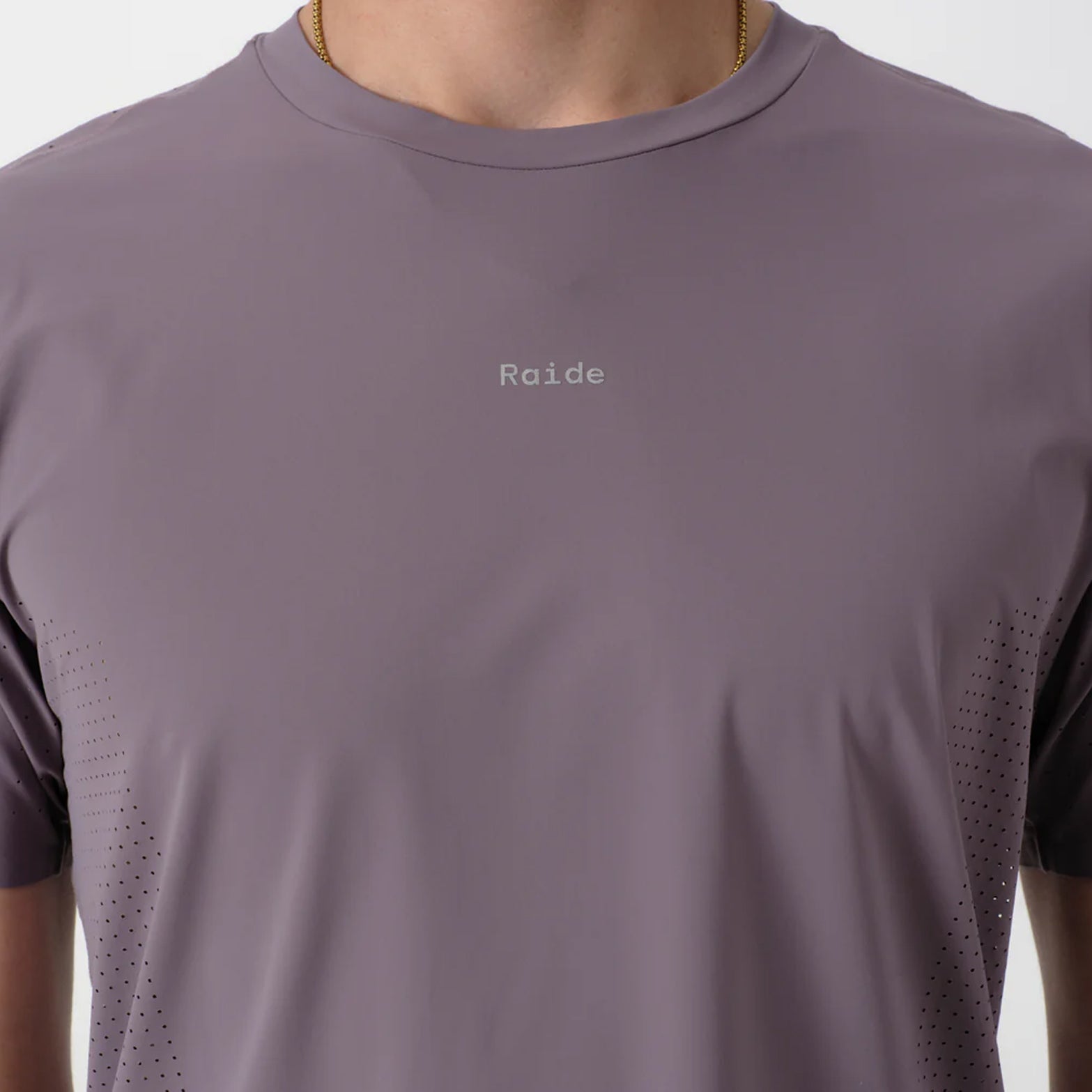 Men's Raide Thermal Dispersion Tee Dusk close-up of front showing reflective Raide branding with body-mapped laser-cut perforations and cool-to-touch 115gsm Italian-knit microfibre construction
