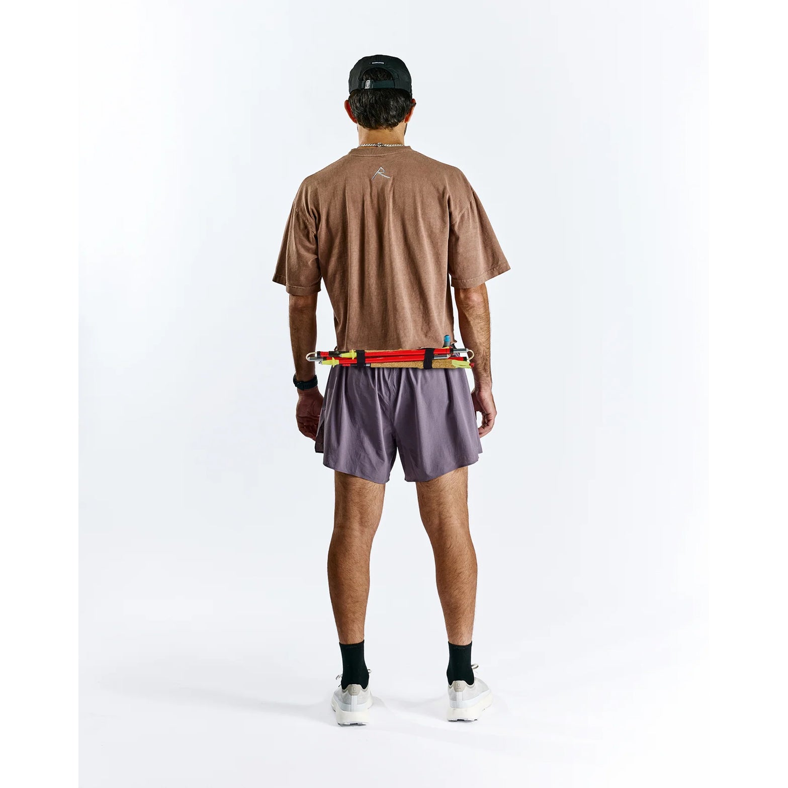 Raide TrailTech Short men's in Dusk — full body back view worn on model showing large rear pocket placement, zippered pocket detail and Toray DotAir outer construction in motion on trail