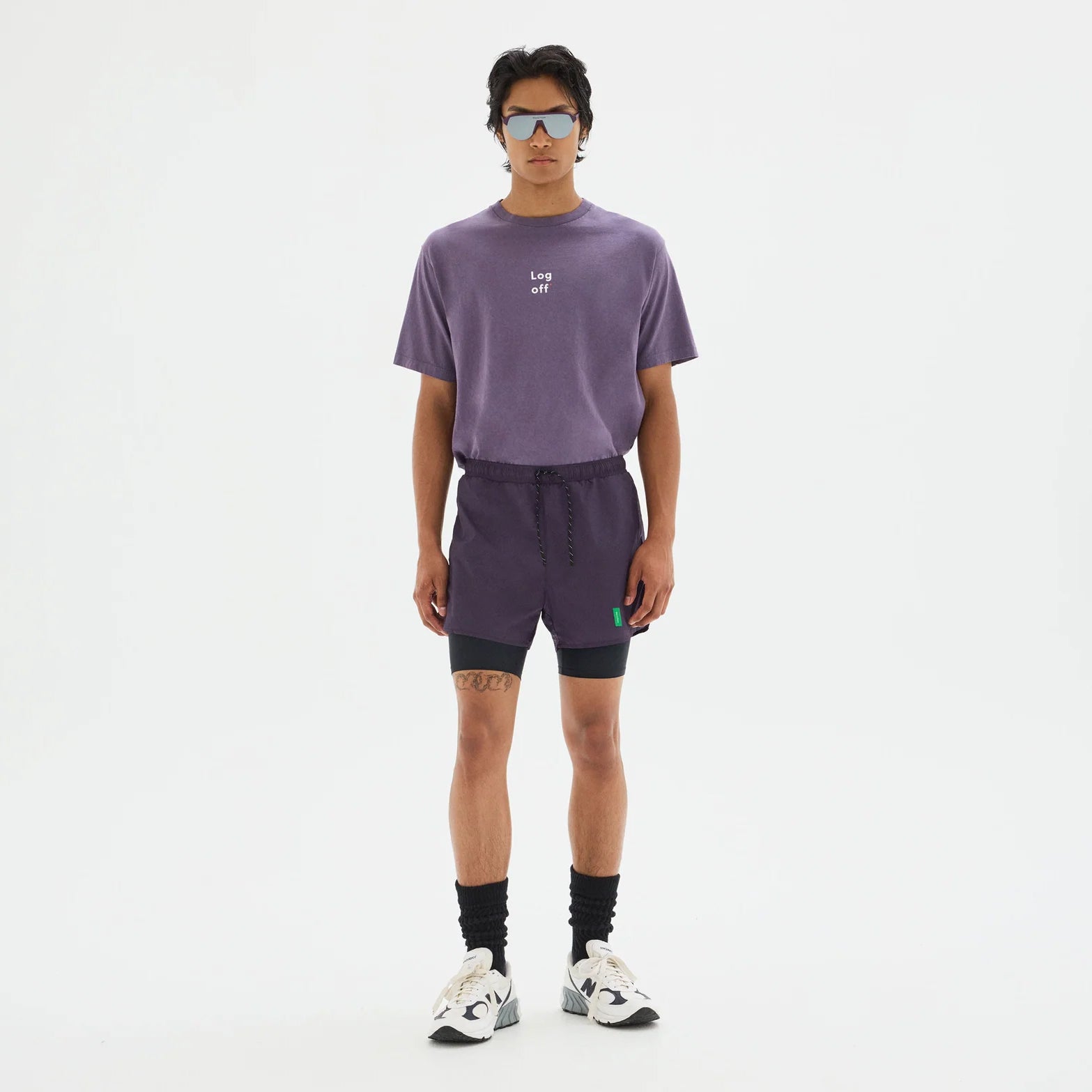 District Vision Men's Ultralight Nylon Trail Short Nightshade Black full body view on male trail runner showing recycled half tights with ultralight shell and concealed phone pocket under outer layer