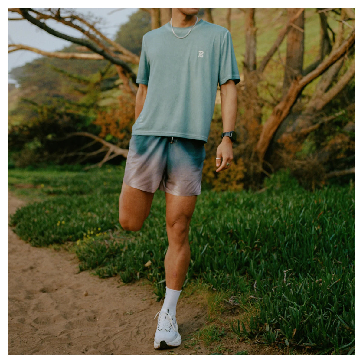 Bandit Vento™ 5 Inch Run Shorts men's in Flow State Aegean Multi — lifestyle shot worn on model showing 5 inch silhouette, flow state aegean multi Vento™ four-way stretch fabric and custom branded drawstring waistband 