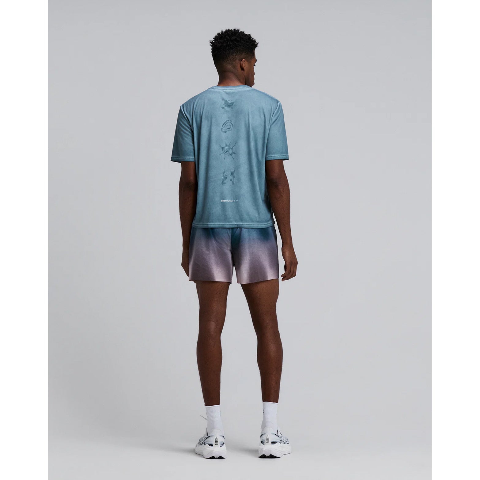 Bandit Vento™ 5 Inch Run Shorts men's in Flow State Aegean Multi — full body back view worn on model showing back zip pocket, bonded cutaway split and flow state aegean multi Vento™ fabric in motion