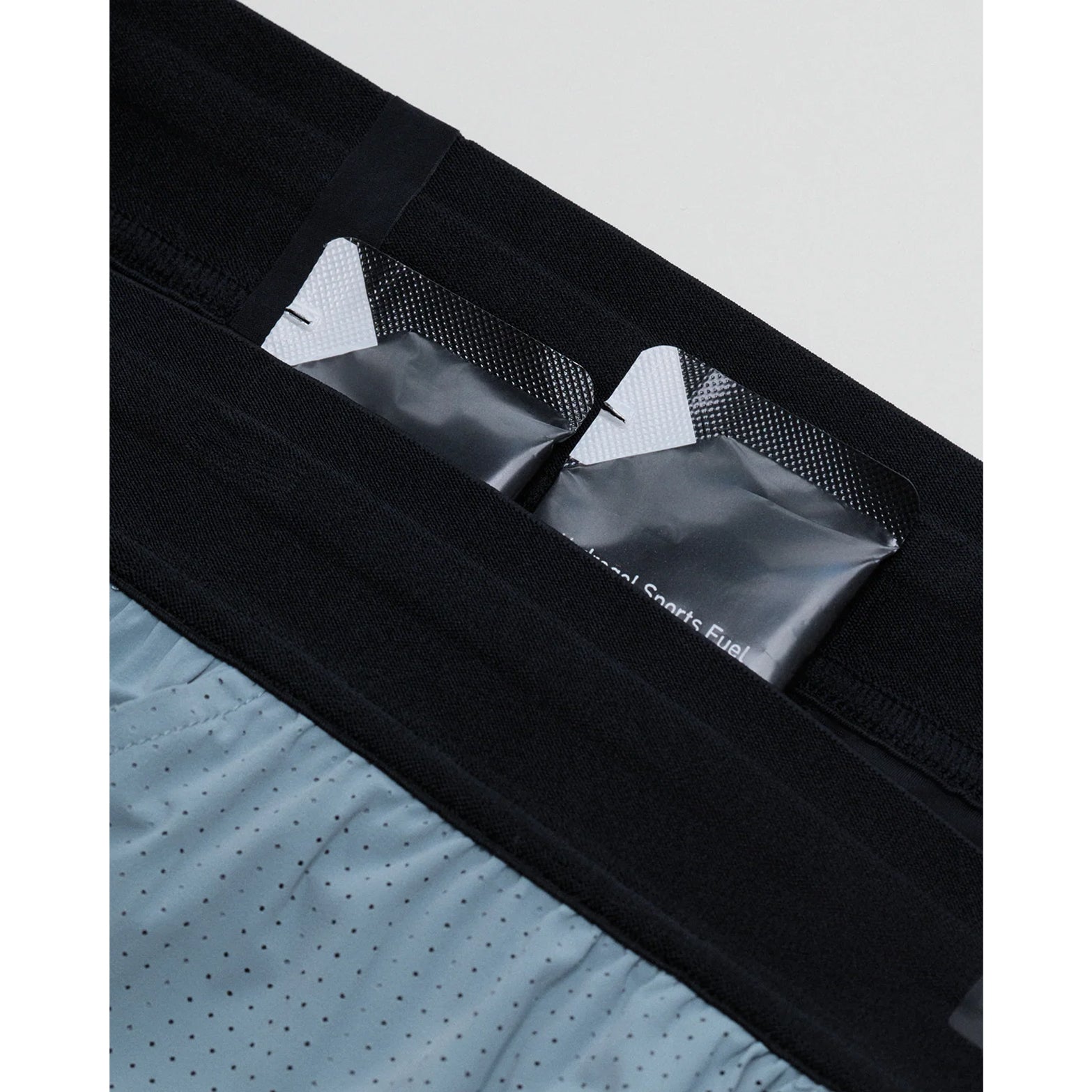 Men's Bandit Vento Next Gen 2-in-1 Run Short Cacao close-up of 4 gel pockets, 2 zippered stash pockets and key clip showing comprehensive 8-pocket storage system