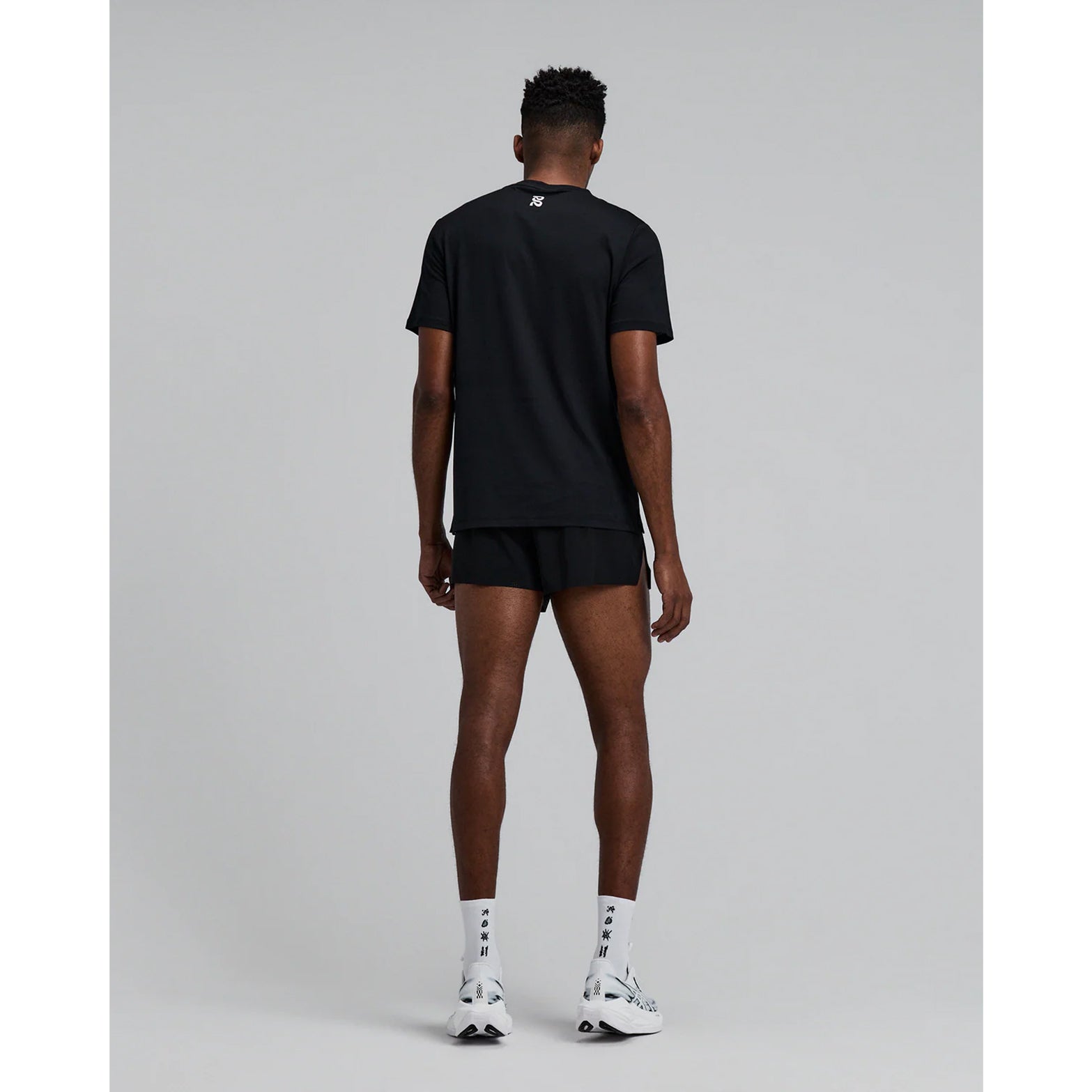 Men's Bandit Vento Next Gen 3 Inch Split Short Black full body back view on male runner showing bonded cutaway split, waterproof phone pocket and gel storage system