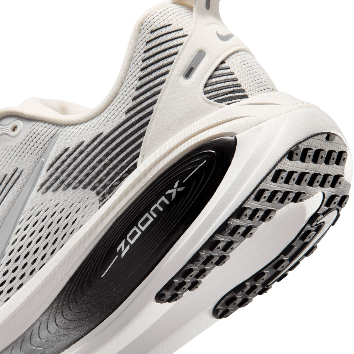 Nike Vomero 18 men's running shoe in Summit White / Black / Off White / Metallic Silver — angled side view showing summit white engineered mesh upper, metallic silver accent detailing and dual-density ZoomX ReactX midsole profile