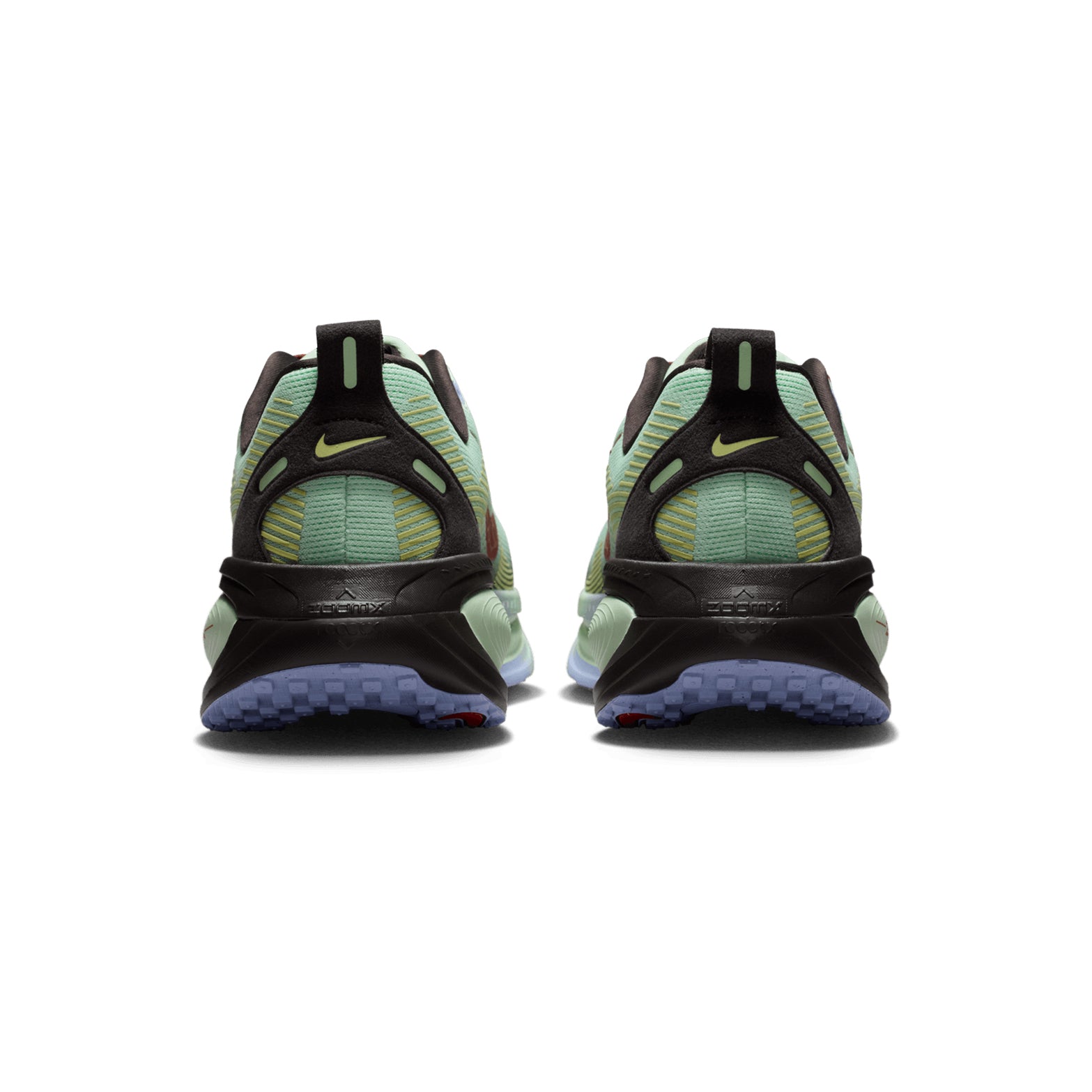 A pair of Nike Men’s Vomero 18 SE Running Shoes in Frosted Spruce, Tar, Purple Fade, and Rugged Orange, shown from the back with a subtle yellow Nike logo, a textured blue sole, and dual-density cushioning designed for road running.