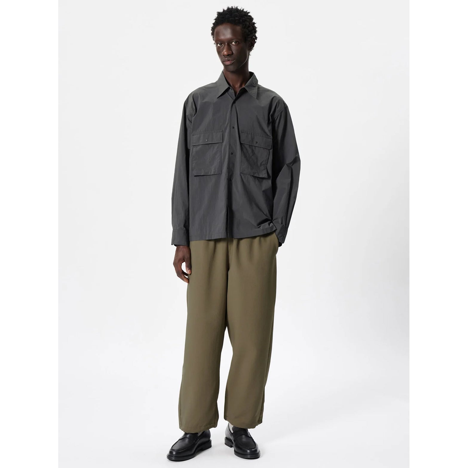 Goldwin Men's Wide Ankle Easy Pants Sand Land full body view on male model showing distinctive wide silhouette with elastic waistband and drawstring