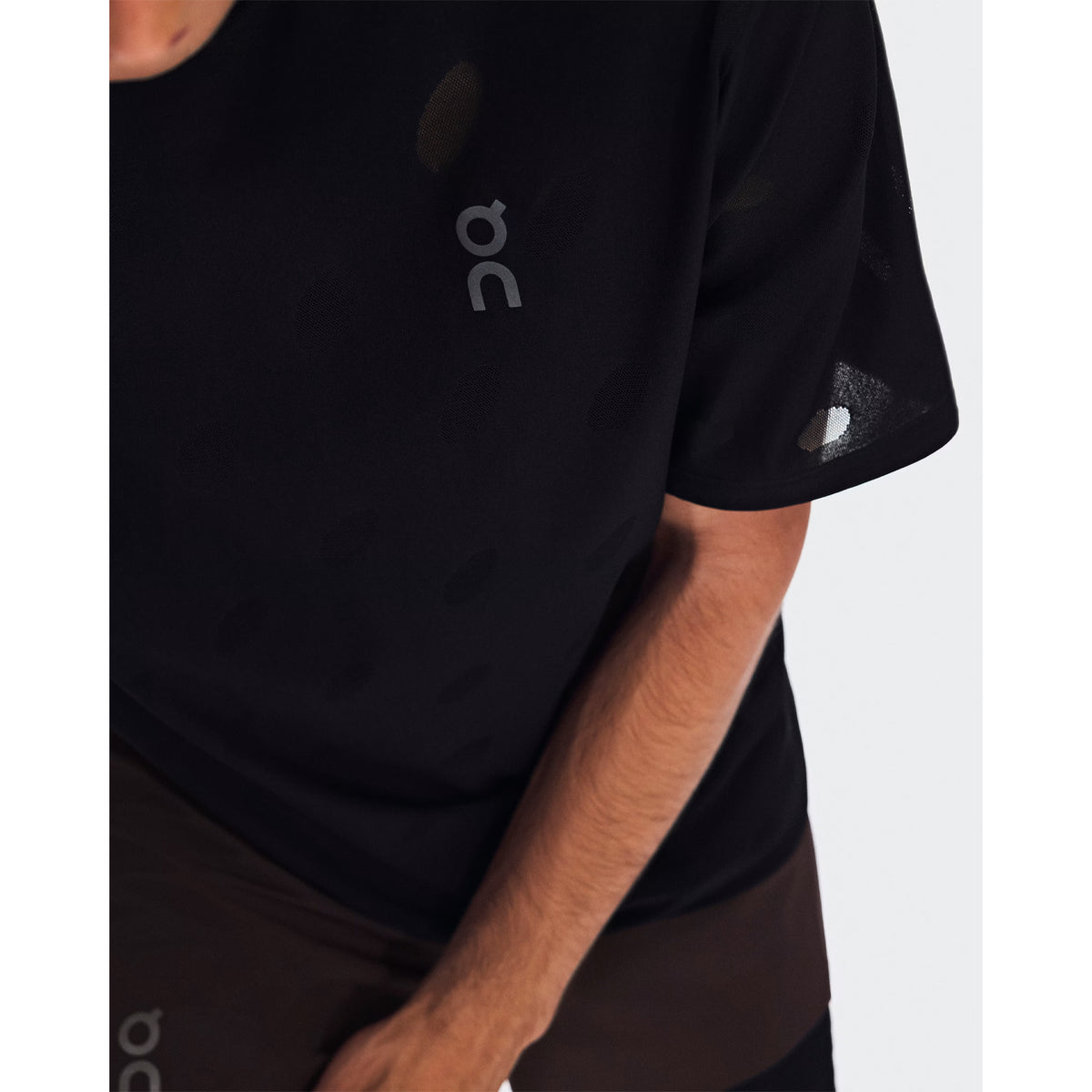 Men's On Zero-T Breathe Black close-up of distinctive functional jacquard fabric showing On DryTec breathable moisture-wicking construction for ultralight distraction-free training