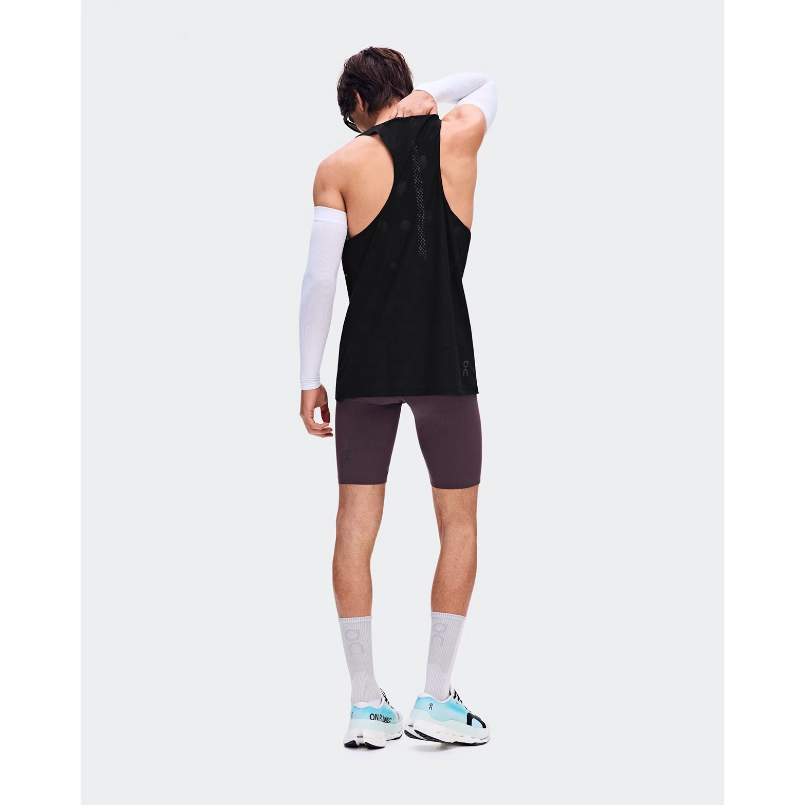 Men's On Zero Half Tights Urchin back full body view on male runner showing engineered bonded back pockets with OAC-inspired graphic and lightweight technical fabric for comfortable race day running