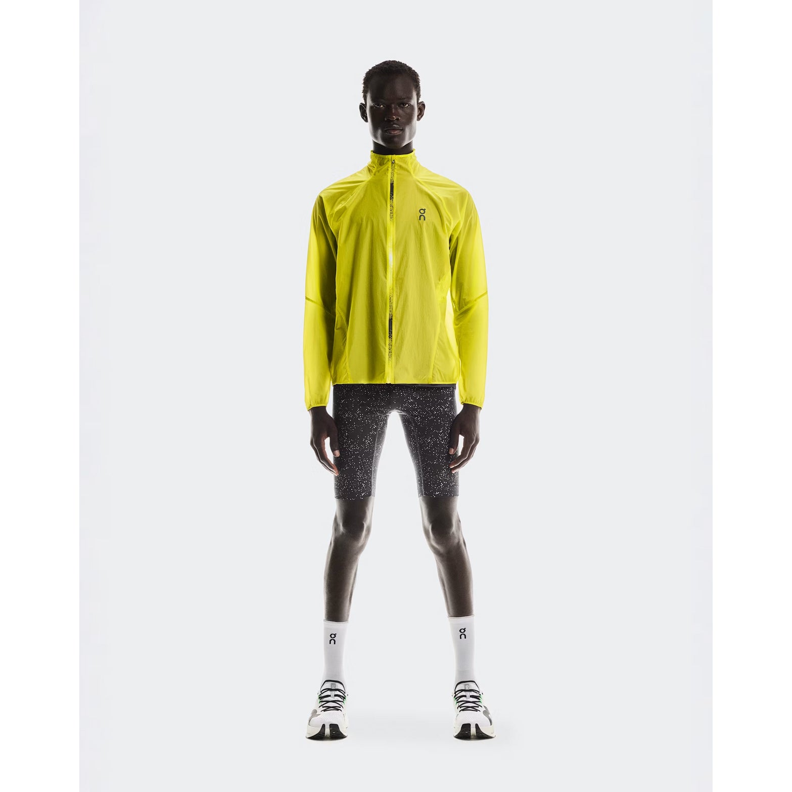 Men's On Zero Jacket Lime full body front view on male runner showing ultralight packable design with windproof water-repellent protection for all-weather running