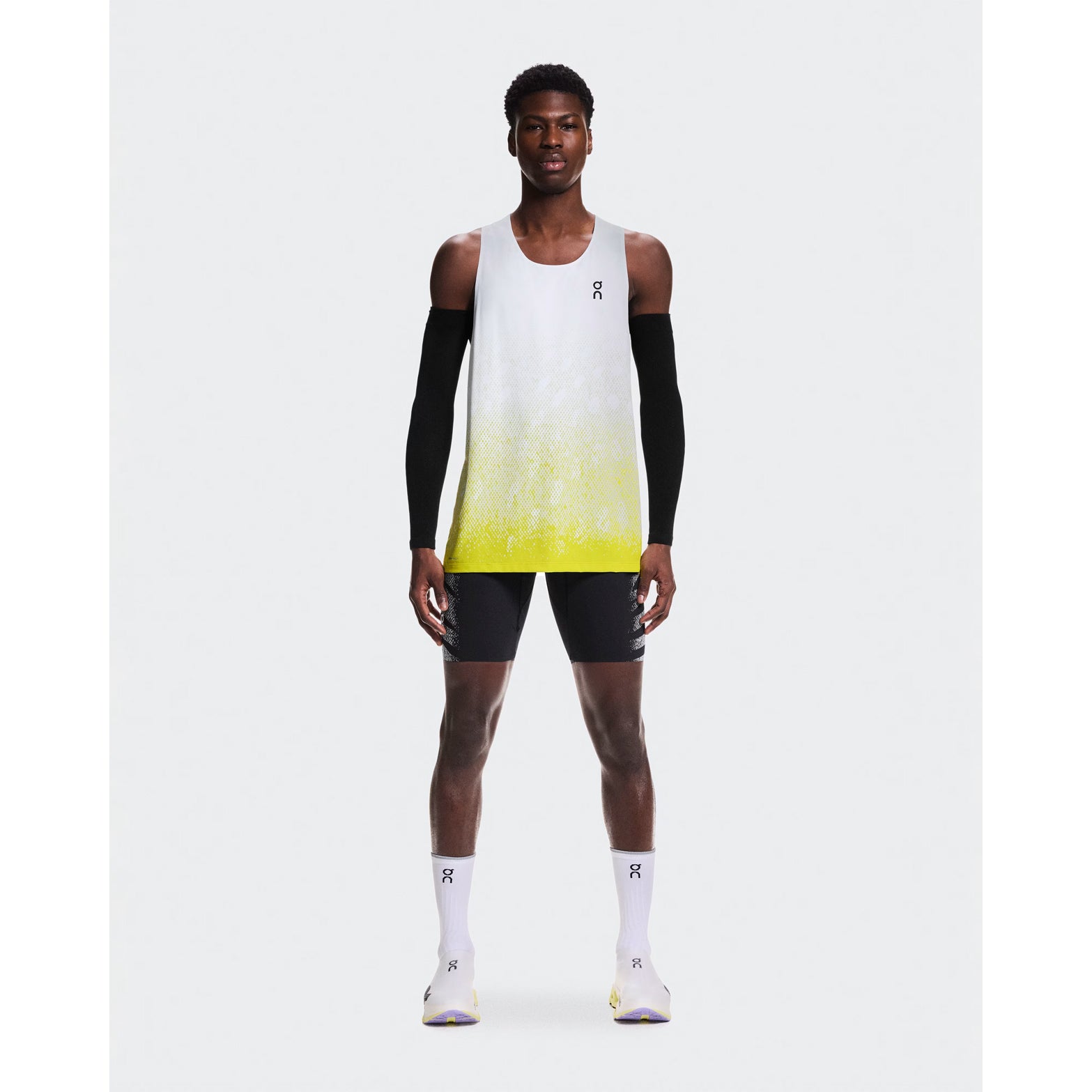 Men's On Zero Singlet White Yellow full body front view on male runner showing ultra-lightweight race day performance and On DryTec moisture-wicking technology