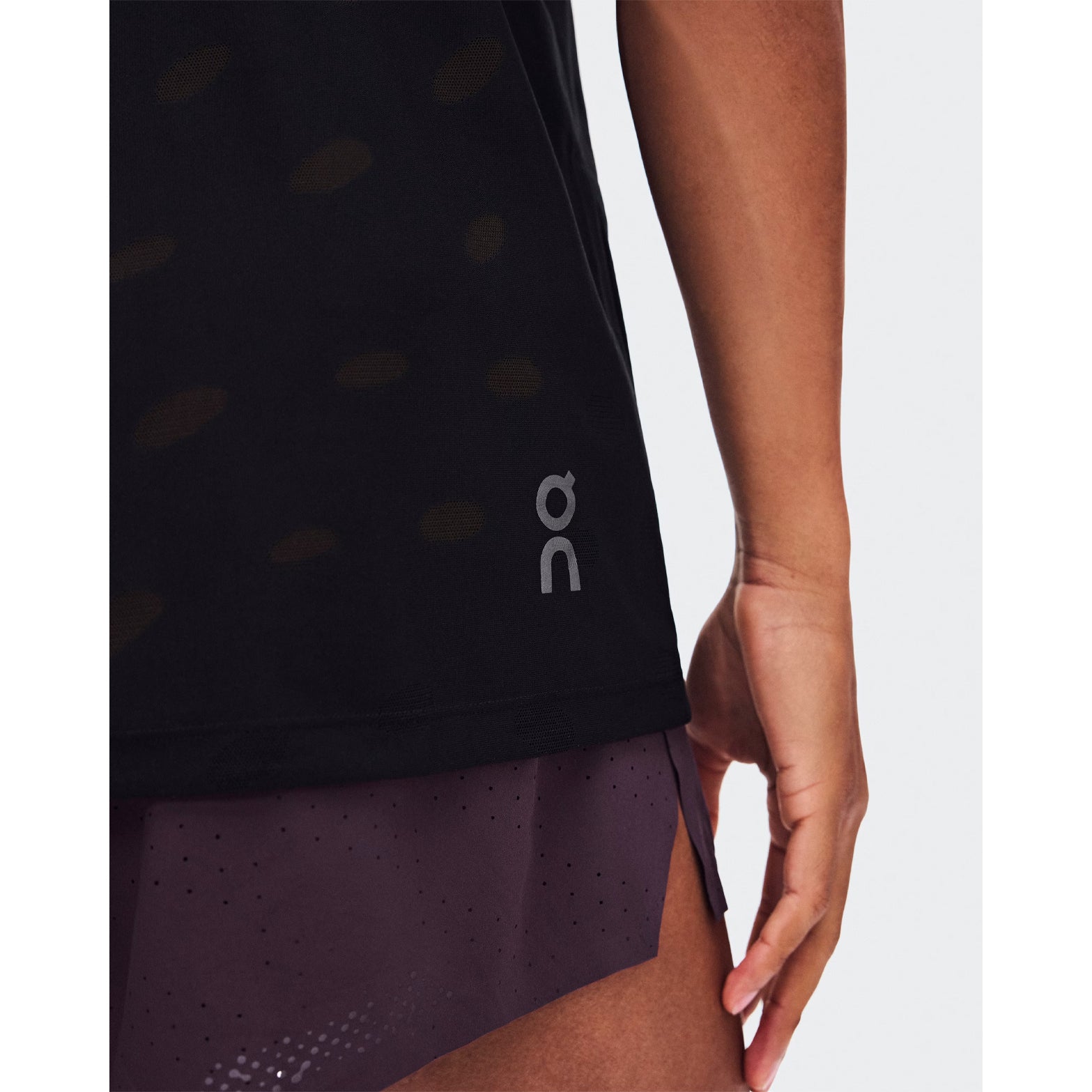 Men's On Zero Tank Breathe Black close-up of hem showing ultralight functional jacquard construction with minimal seam design and On DryTec breathable moisture-wicking fabric for distraction-free training and race day performance