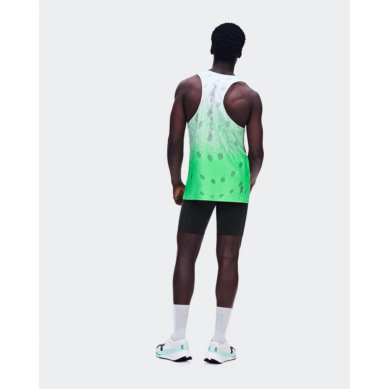 Men's On Zero Tank Breathe Verdite back full body view on male runner showing functional jacquard construction with signature reflective detailing and On DryTec quick-drying fabric for high-paced running