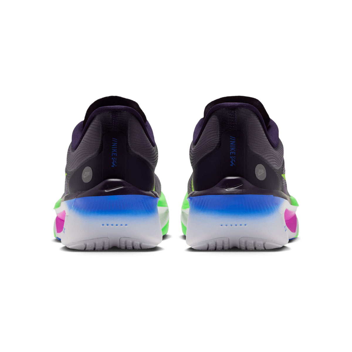A pair of Nike Men’s Zoom Fly 6 RSG Running Shoes in Purple Dynasty, Volt, and Fuchsia Dream is shown from the back, highlighting a vibrant mix of purple, blue, green, white, and pink accents on the heel and sole. These shoes are designed with responsive ZoomX foam cushioning and a carbon fibre plate for an energized ride.
