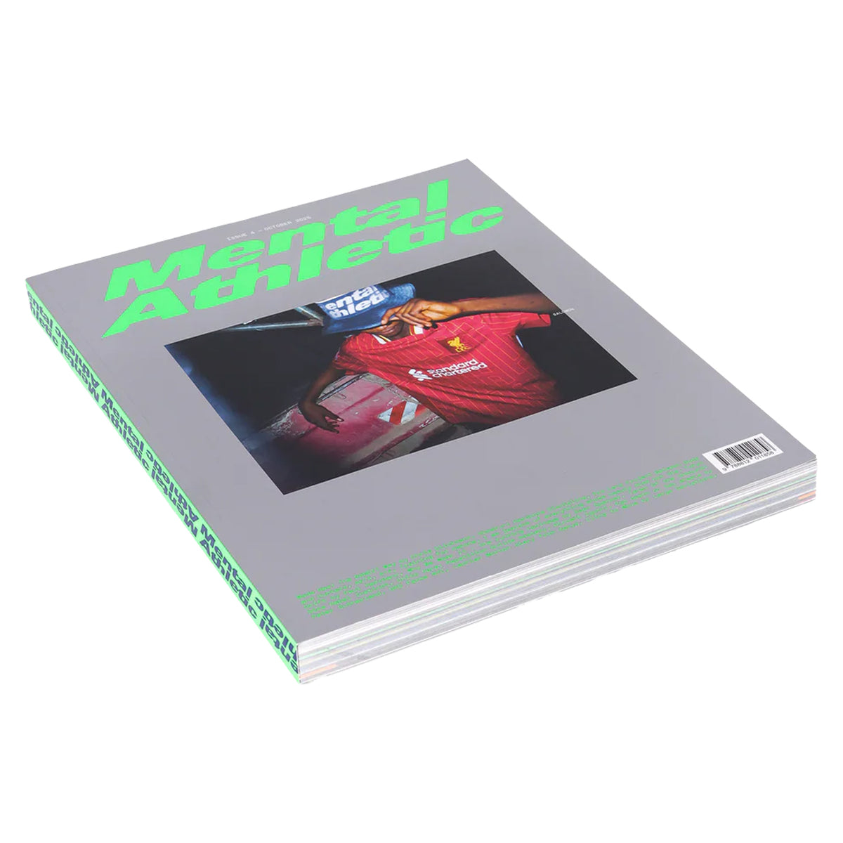 A magazine titled Mental Athletic with a gray cover, neon green text, and a photograph of a person in a red jersey holding a microphone. A barcode is visible on the bottom right corner.