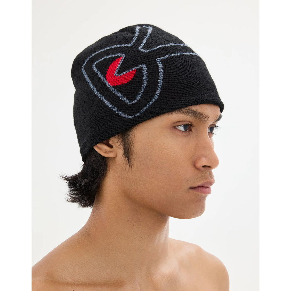 A breathable black District Vision Merino Wool Beanie Black / Red, featuring a red and grey graphic logo on the side.