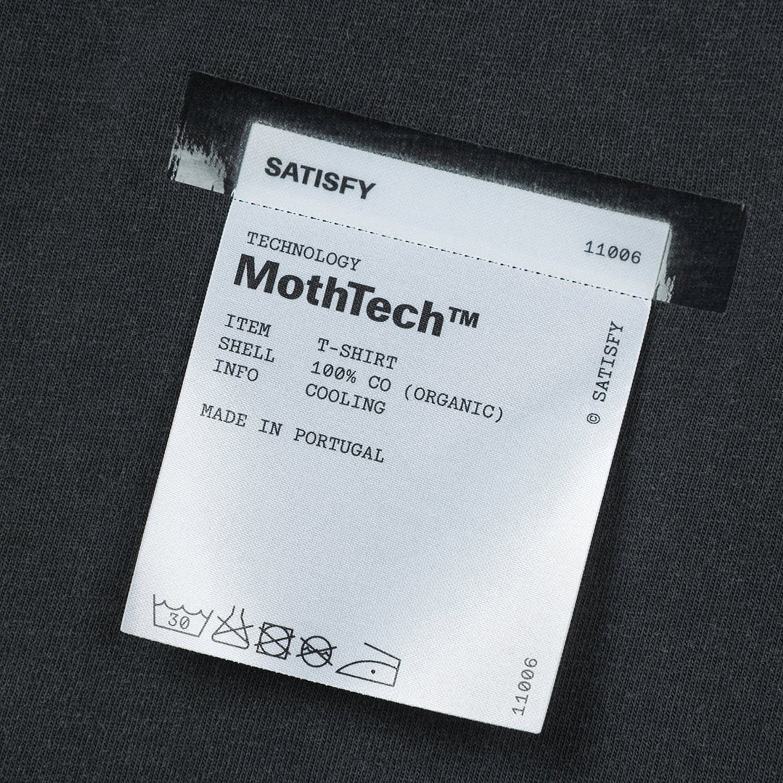 Satisfy MothTech Tee Aged Black close-up of fully detachable exterior care label with nothing inside interfering with skin contact