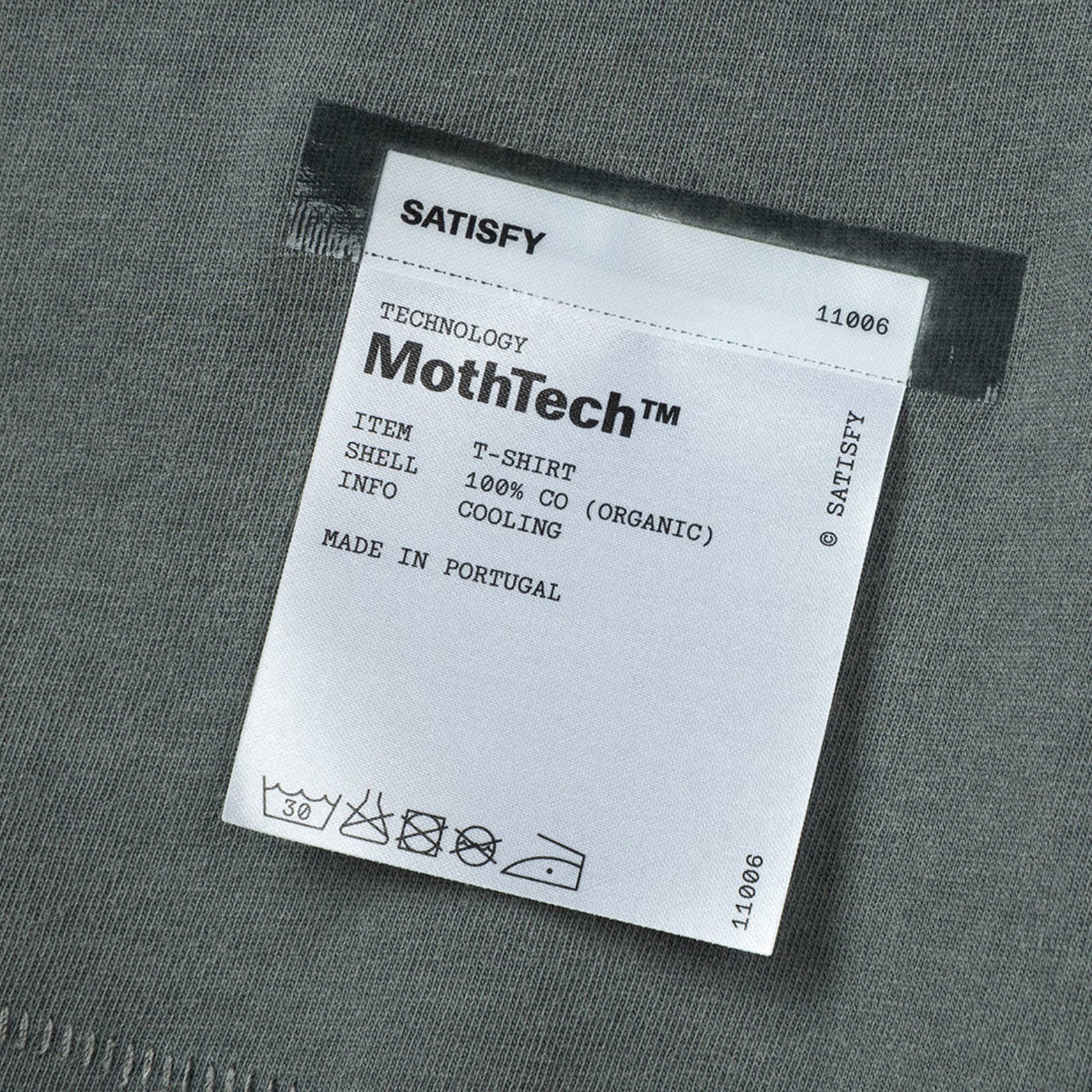 Satisfy MothTech Tee Faded Black close-up of fully detachable exterior care label with nothing inside interfering with skin contact