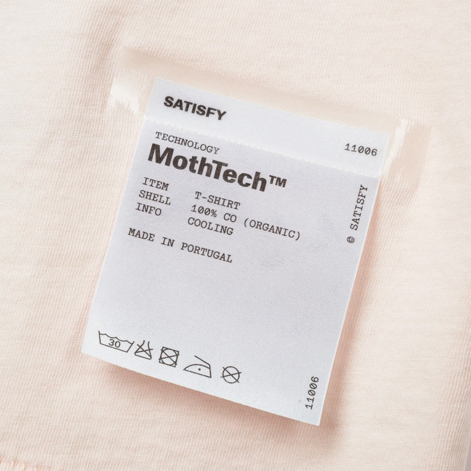 Satisfy MothTech Tee Sun Bleach Sand close-up of fully detachable exterior care label with nothing inside interfering with skin contact