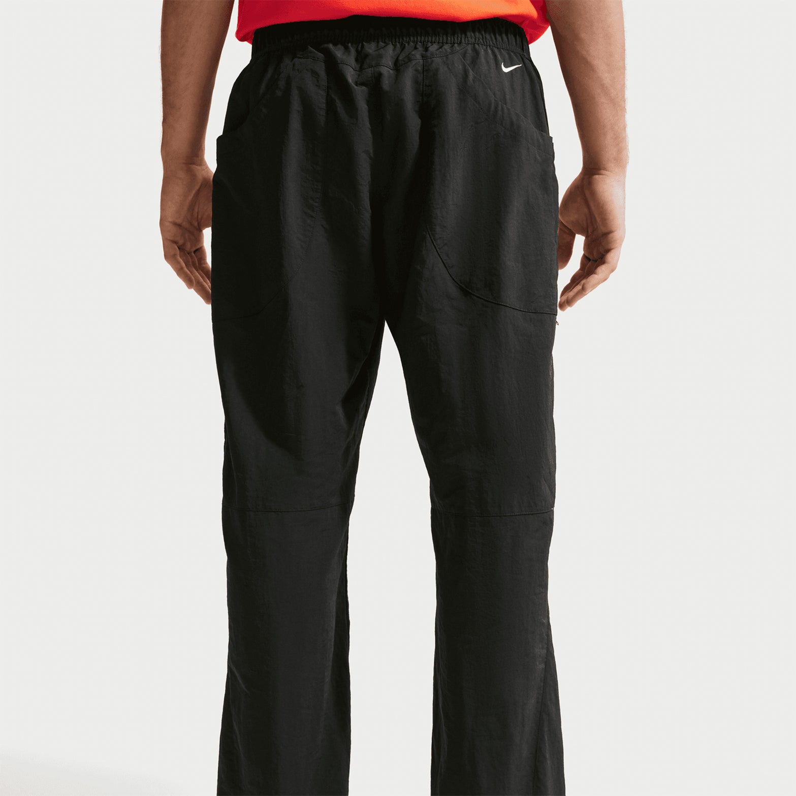 Nike Men's ACG Dolomiti Trousers Black Summit White back view on male model showing snap closure back pocket and embroidered Nike ACG logos