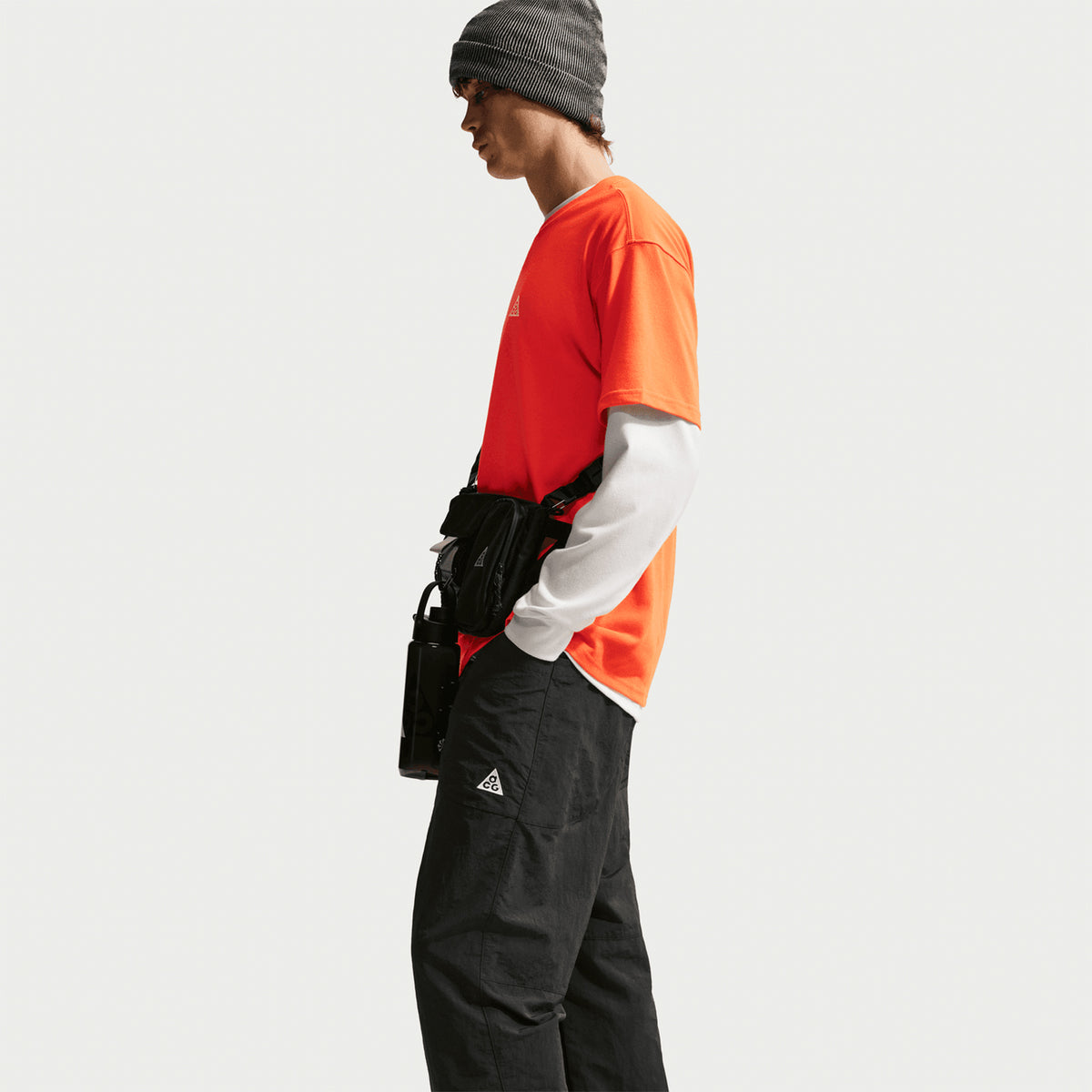 Nike Men's ACG Dolomiti Trousers Black Summit White side view on male model showing 100% nylon construction and loose fit 