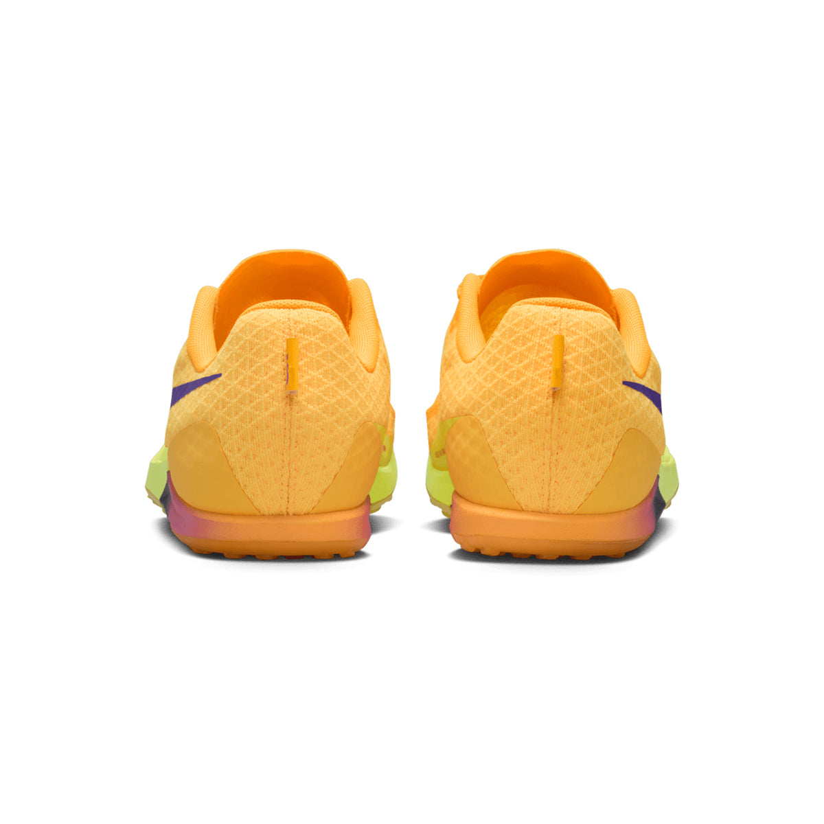 Pair of vibrant Nike Zoom Rival XC 7 Running Spikes in Citron Pulse, Indigo Burst, and Blue Void, seen from the back. These cross-country shoes feature a yellow sole, breathable textured mesh upper, and purple accents on each side. A visible heel tab on both shoes highlights their performance-focused design for cross-country running.
