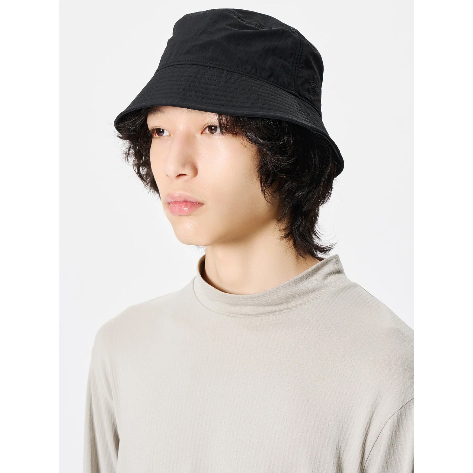 Goldwin Nylon Bucket Hat Black side view on male model showing densely woven fabric with water-repellent treatment for light rain protection