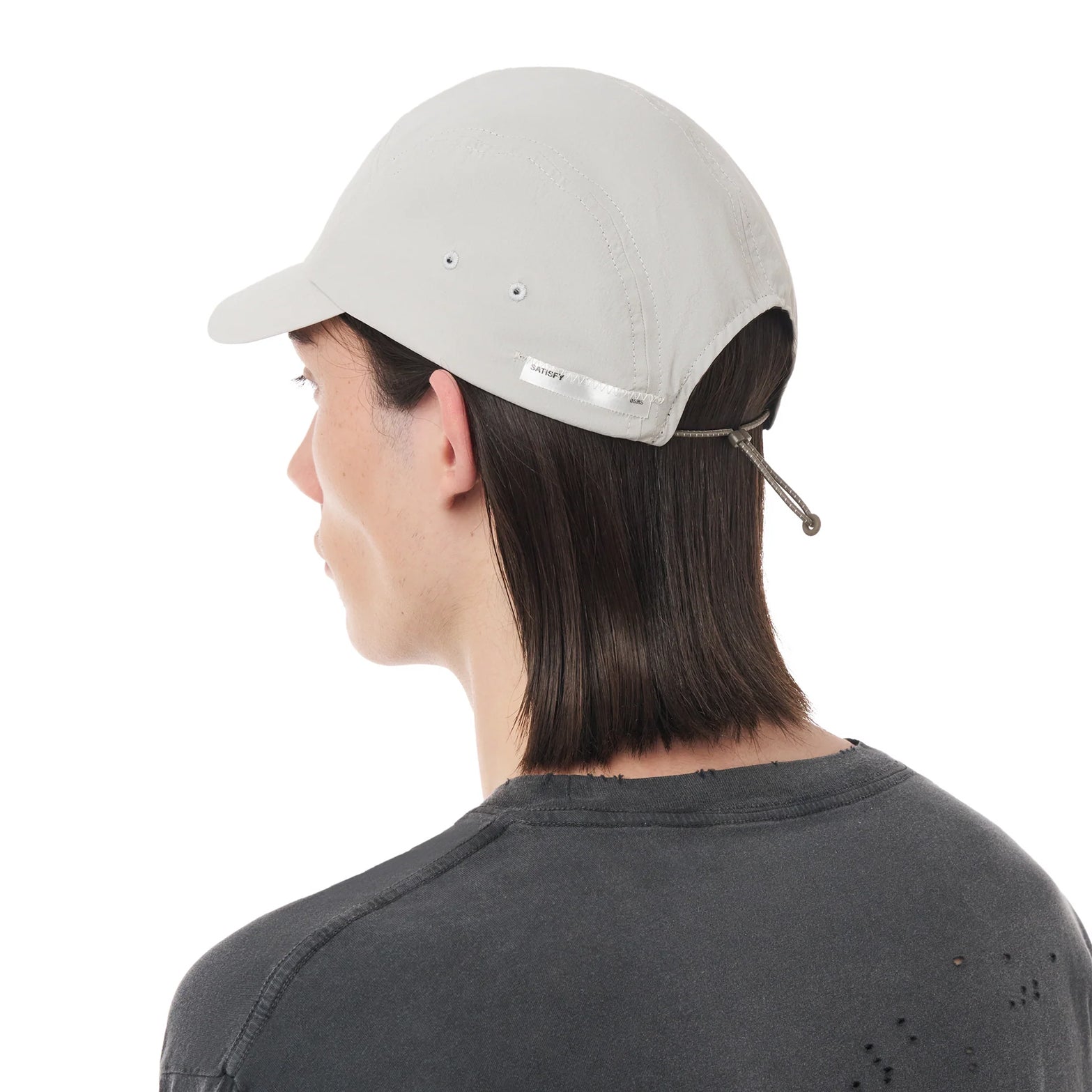 Satisfy PeaceShell Cordura Trail Cap in Light Grey — back view worn on model showing adjustable rear closure system and light grey PeaceShell™ Cordura construction