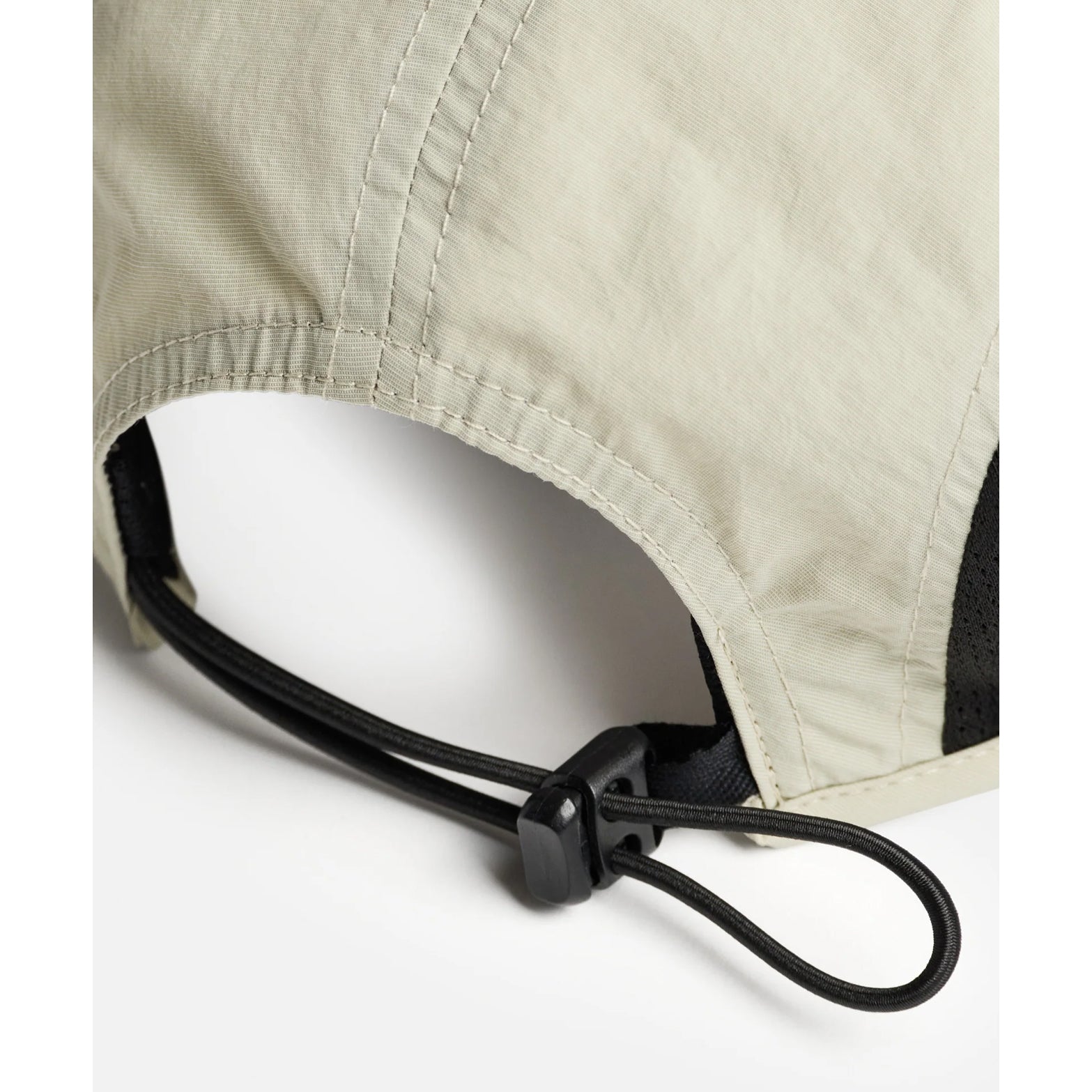 District Vision Performance Panelled Mesh Hat in Sand — back product shot showing quick-release sports clasp, lightweight shock cord loop and sand water-resistant shell construction