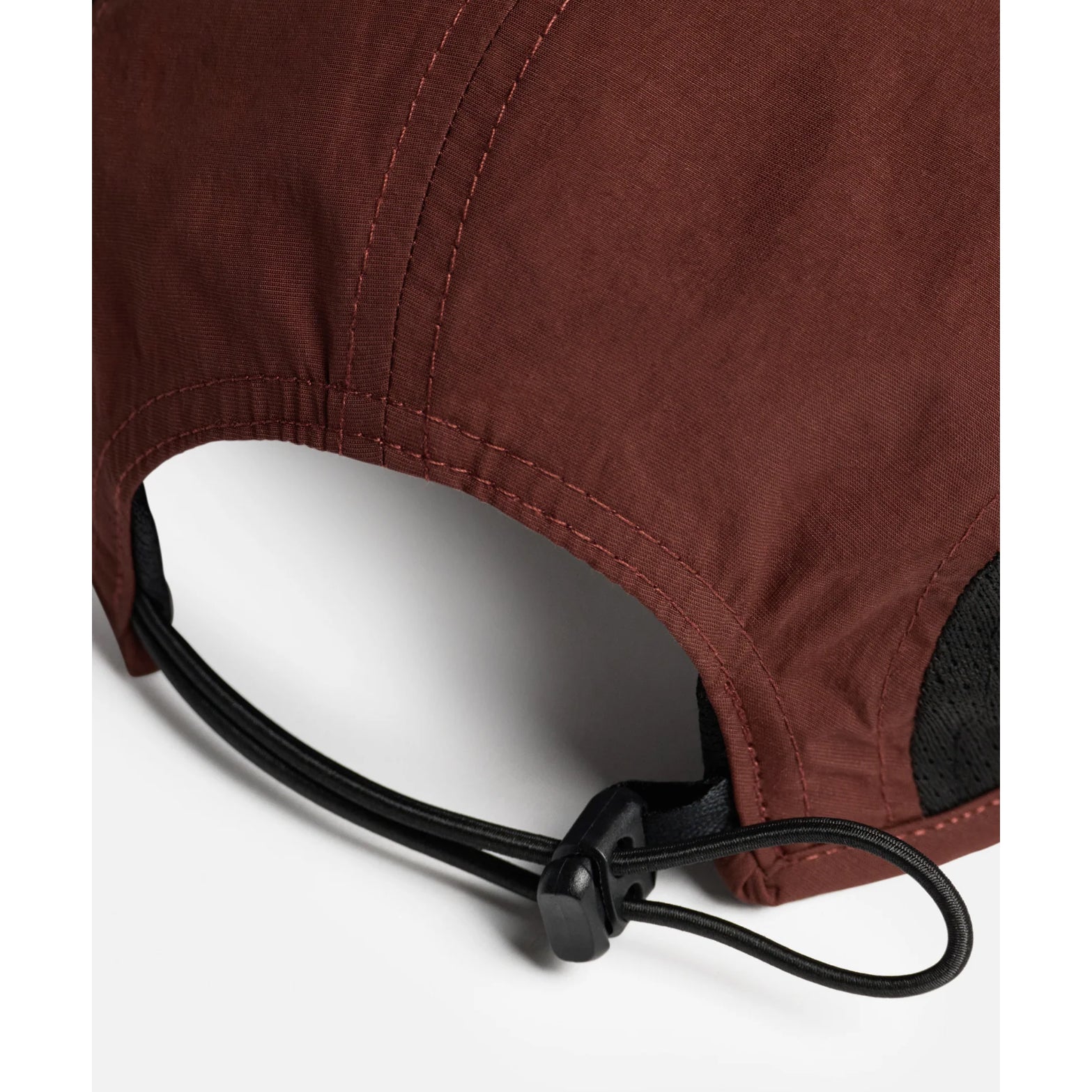 District Vision Performance Panelled Mesh Hat in Terracotta — back product shot showing quick-release sports clasp, lightweight shock cord loop and terracotta water-resistant shell construction
