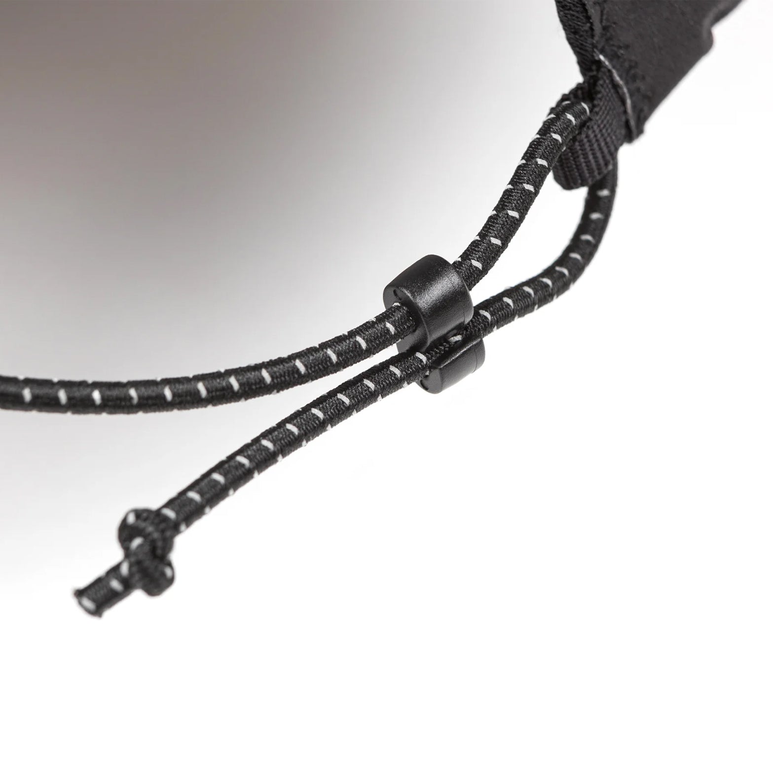 atisfy Pertex® 3L Rain Cap in Black — closeup showing adjustable bungee closure detail on black Pertex® Shield Air nano-ripstop construction
