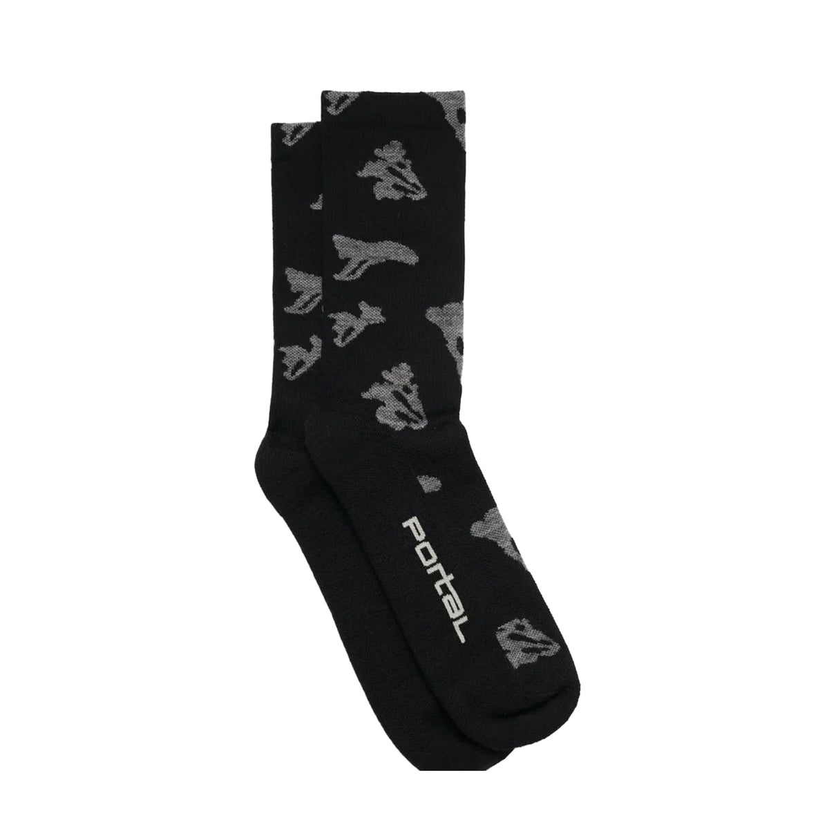 A pair of Portal Ritual Merino Socks in Black Beauty, featuring mid-weight merino wool construction with gray abstract patterns and “Portal” printed in white on the sole, are displayed neatly on a white background.