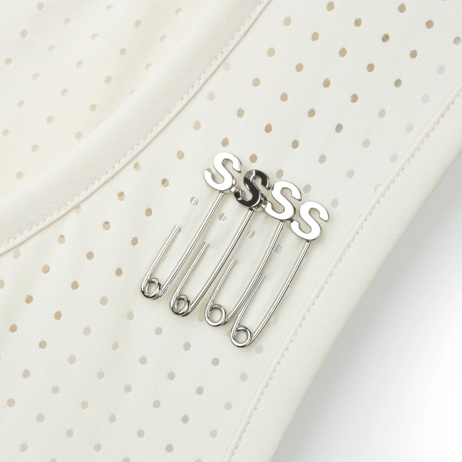 Satisfy Space-O™ Singlet in Chalk — closeup showing four ©Satisfy S-Pins positioned through laser perforations for race-day bib fastening